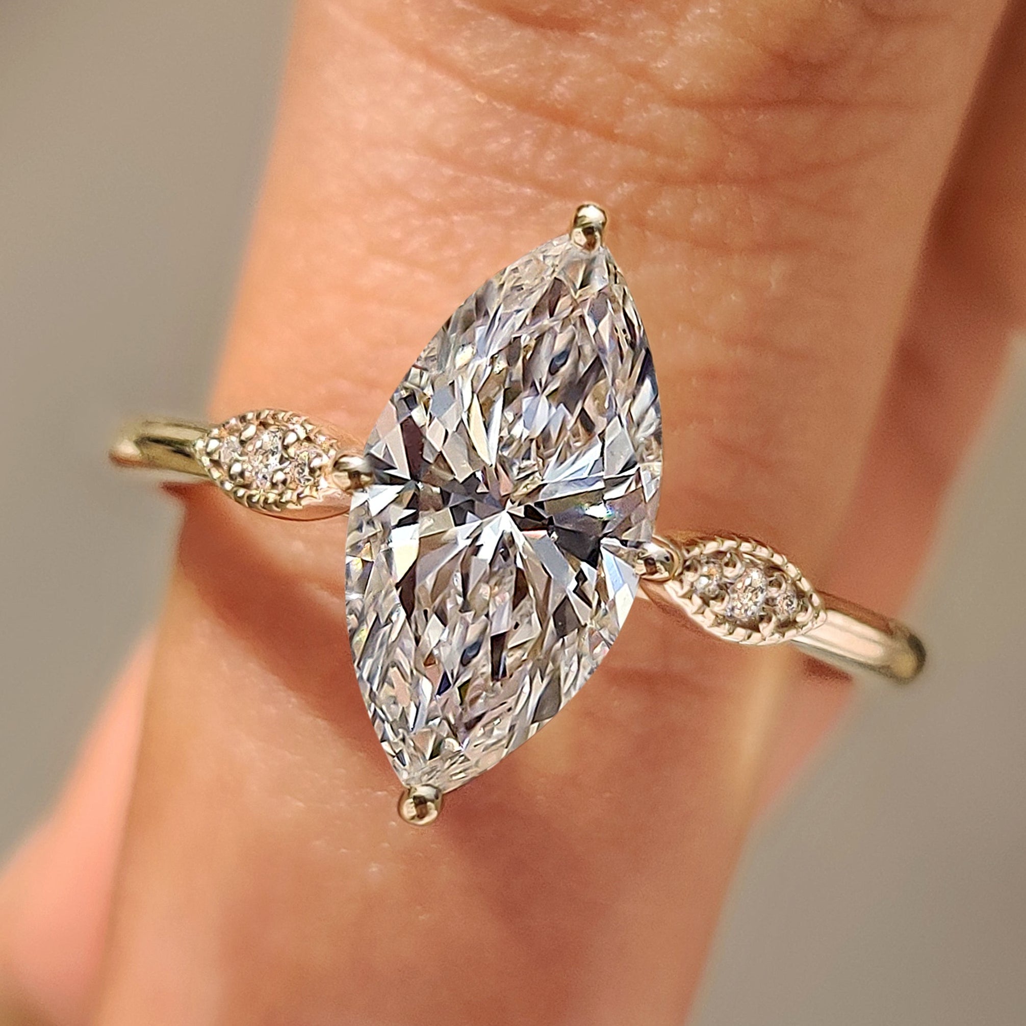 Marquise cut diamond ring with round side stones.
