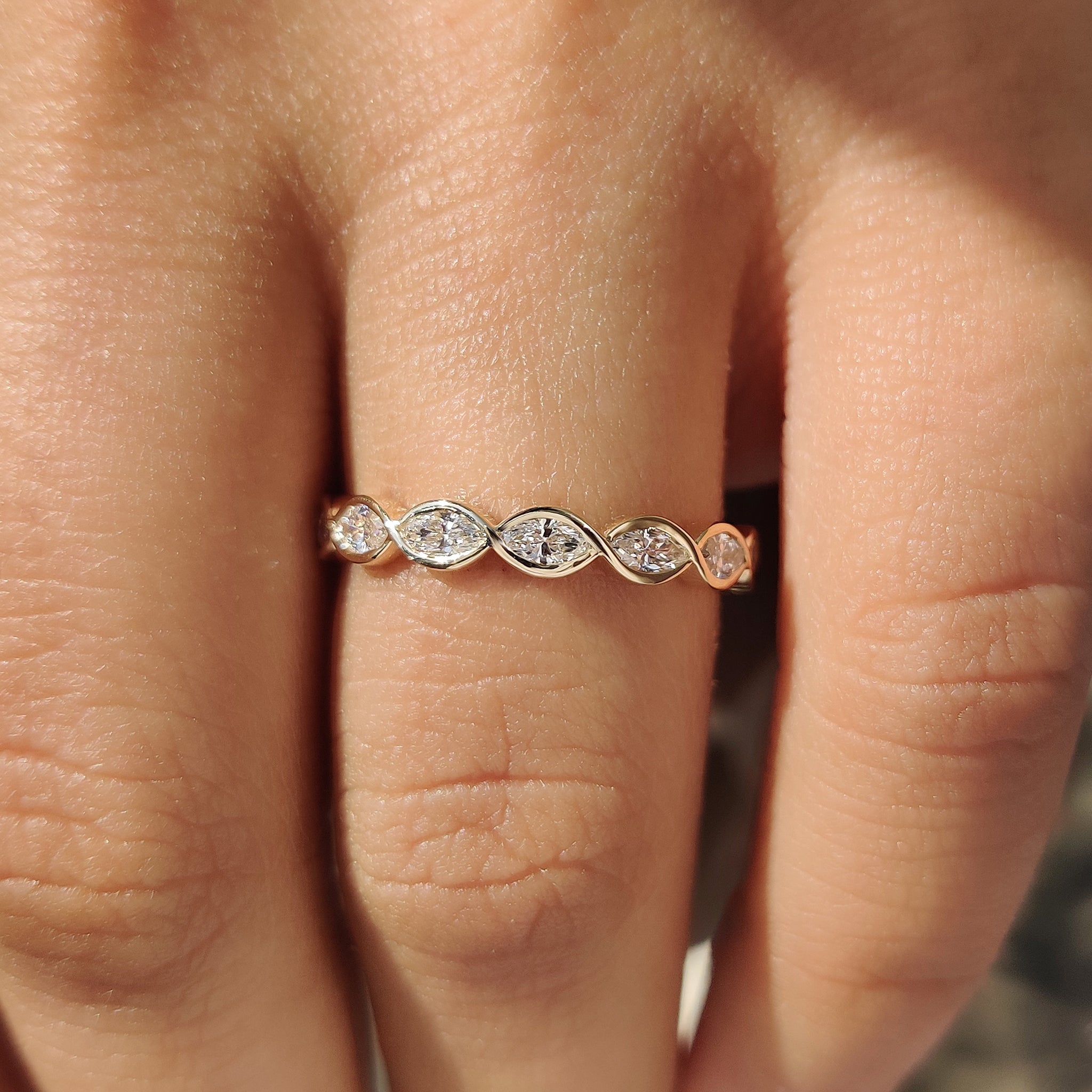 Handmade marquise diamond wedding band with unique twisted shank.
