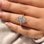 Round side stones add brilliance to marquise cut engagement ring.
