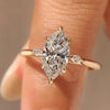 Marquise diamond engagement ring with three stone style design.
