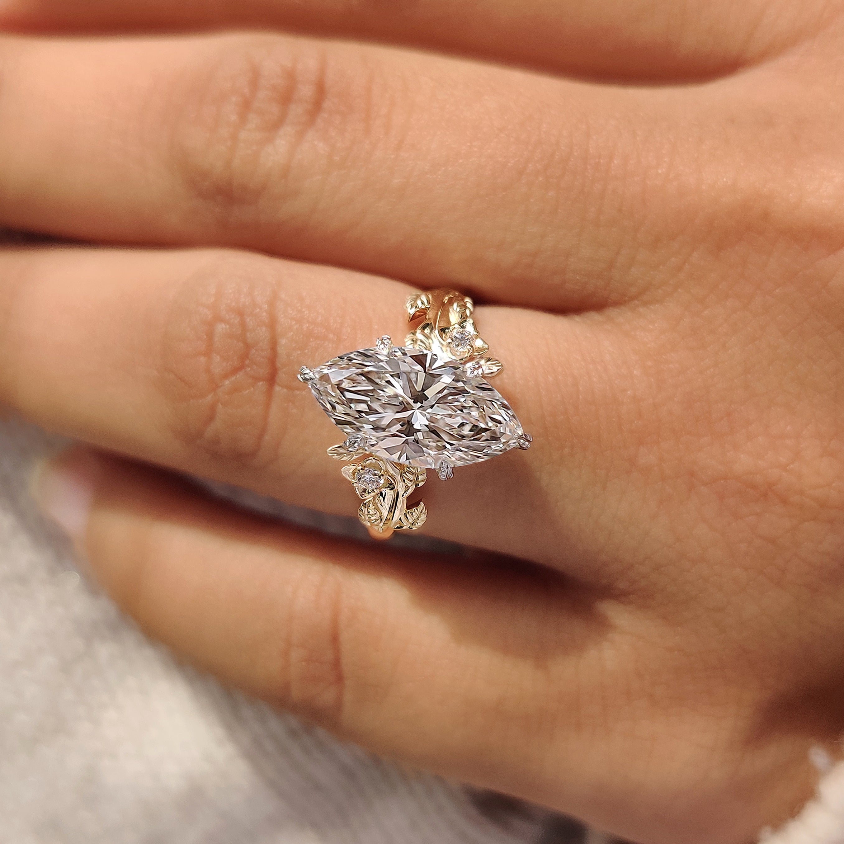 Nature inspired engagement ring with leaf style shank

