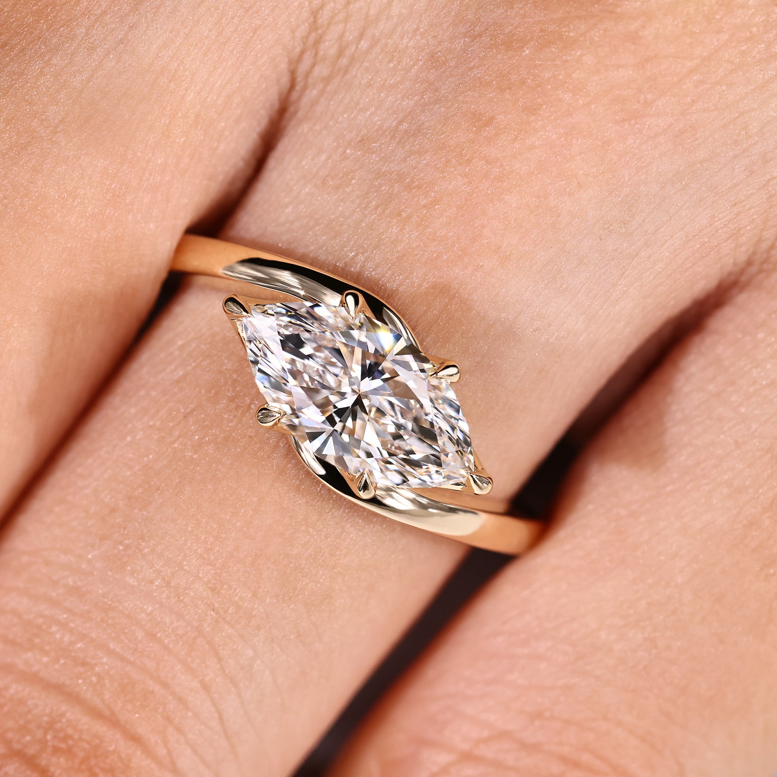 Marquise diamond ring with horizontal east west placement

