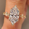 Marquise cut lab grown diamond ring with round side stones.
