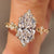 Marquise cut lab grown diamond ring with round side stones.

