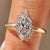 Marquise cut ring with round cut cluster setting.
