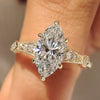 Marquise cut lab grown diamond ring with round side stones.
