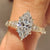 Marquise cut lab grown diamond ring with round side stones.
