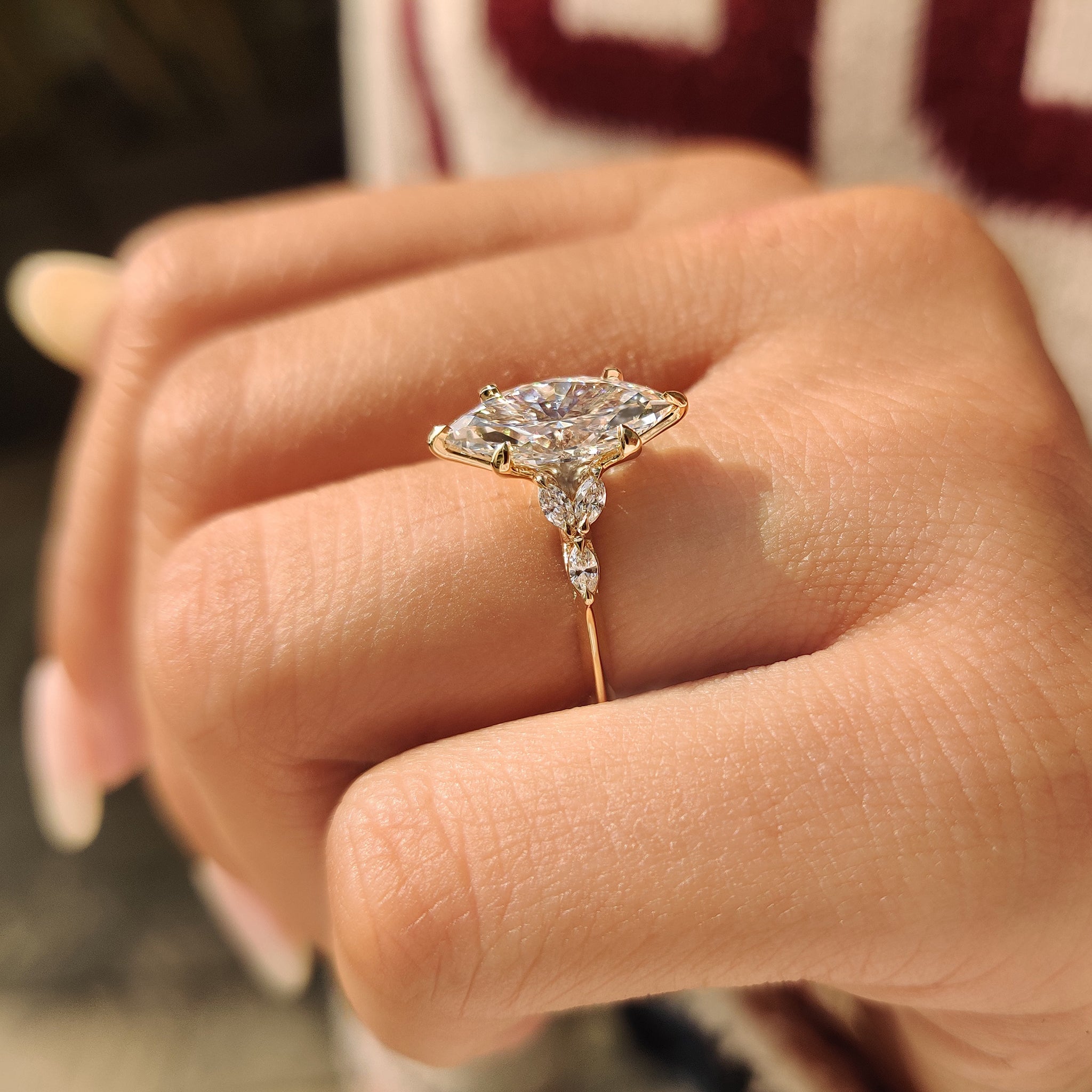 Marquise diamond ring with knife edge band and six claw prong
