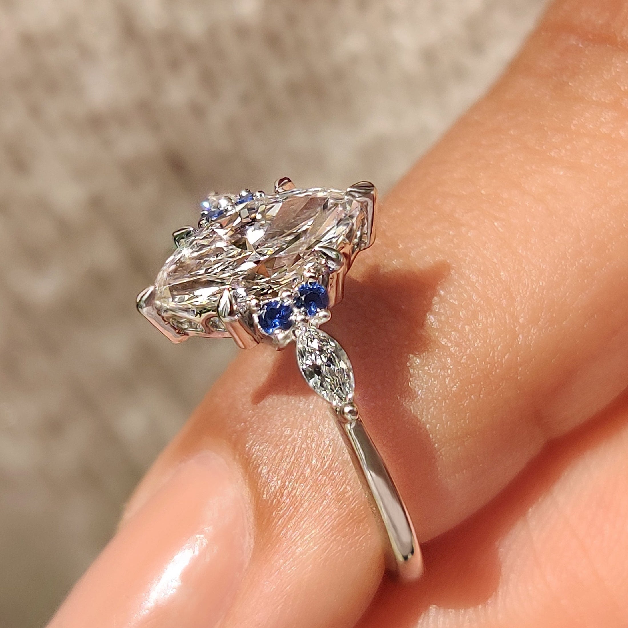 Marquise diamond ring with muse setting and sapphire sides
