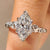 Marquise cut diamond ring with round side stone accents

