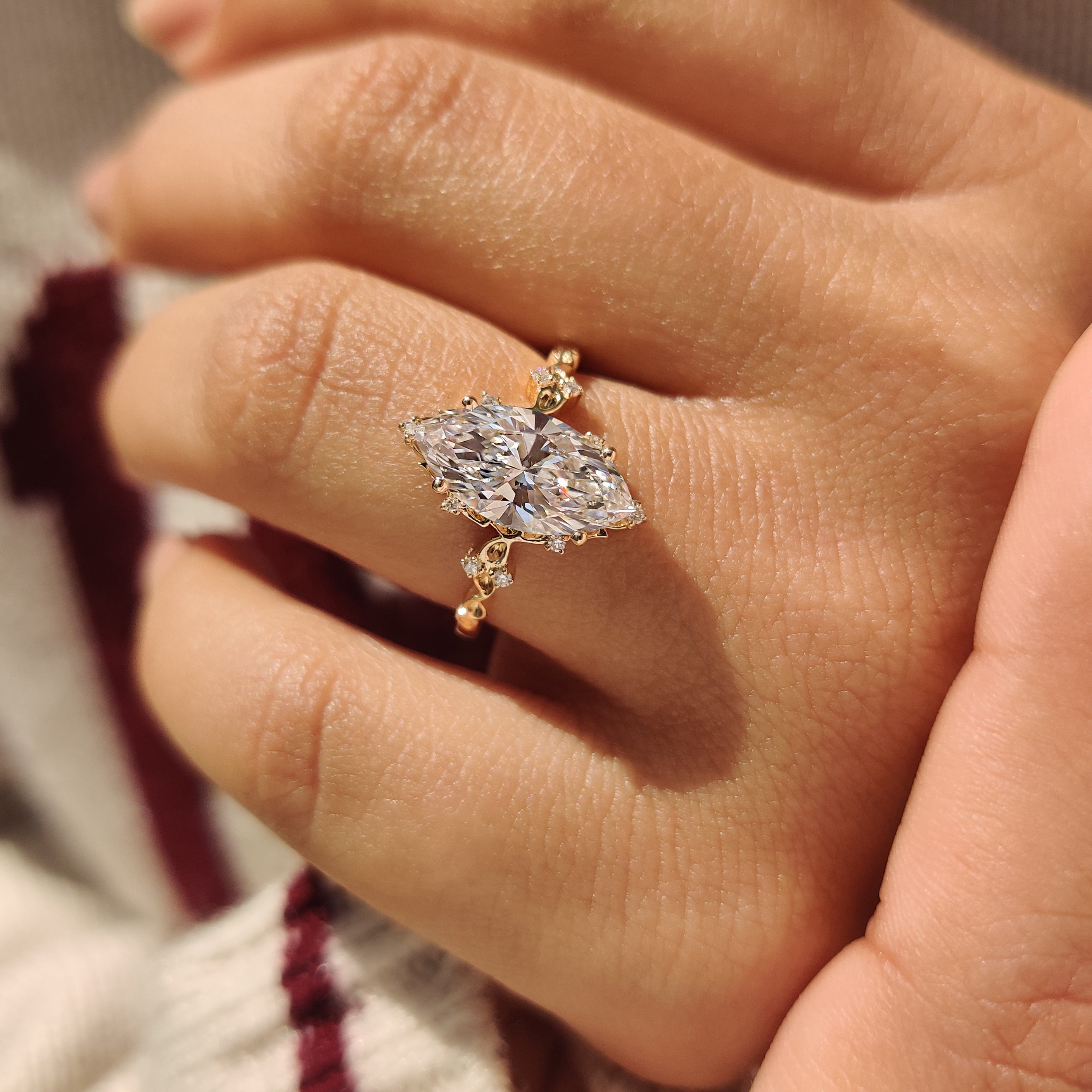 Handmade marquise diamond ring with round cluster stones.
