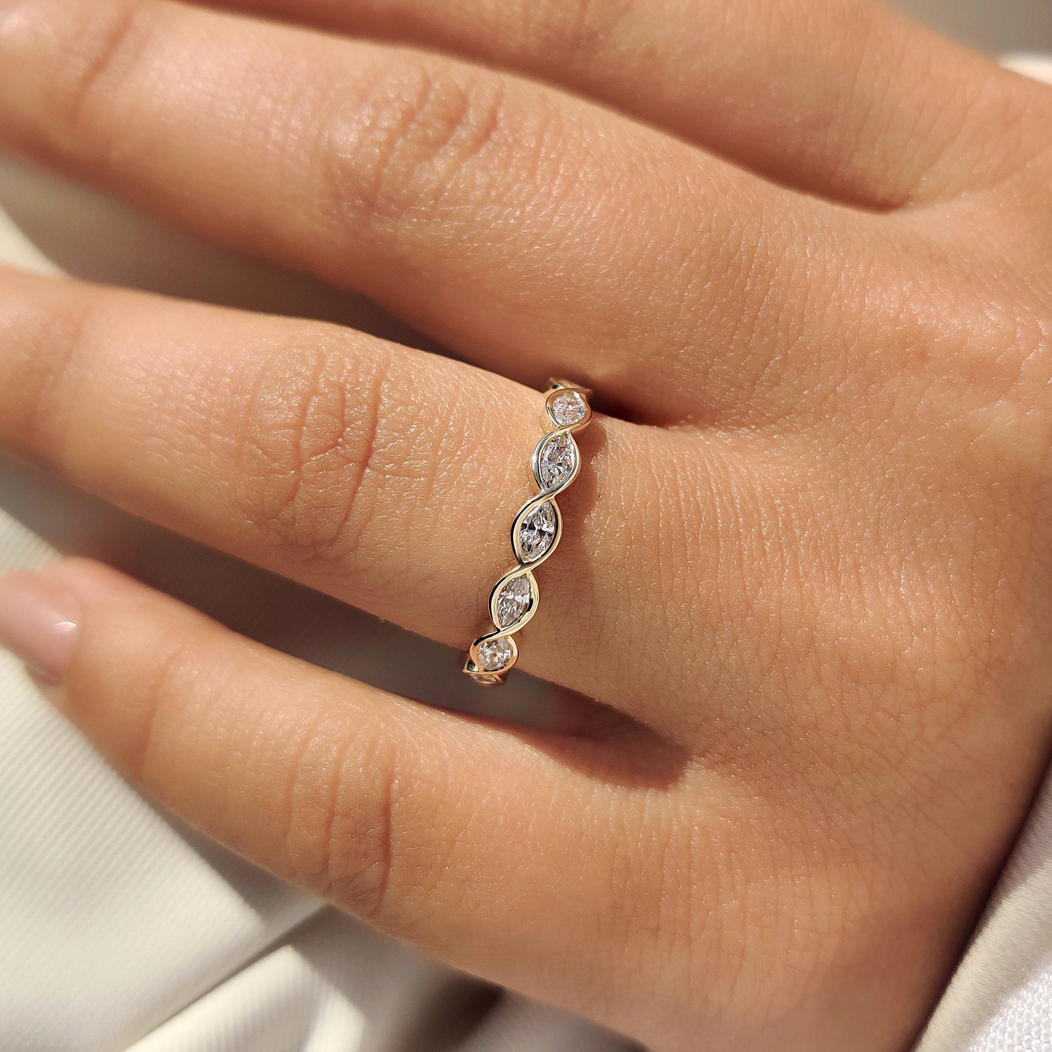 Lab grown marquise diamond eternity band with twisted shank.
