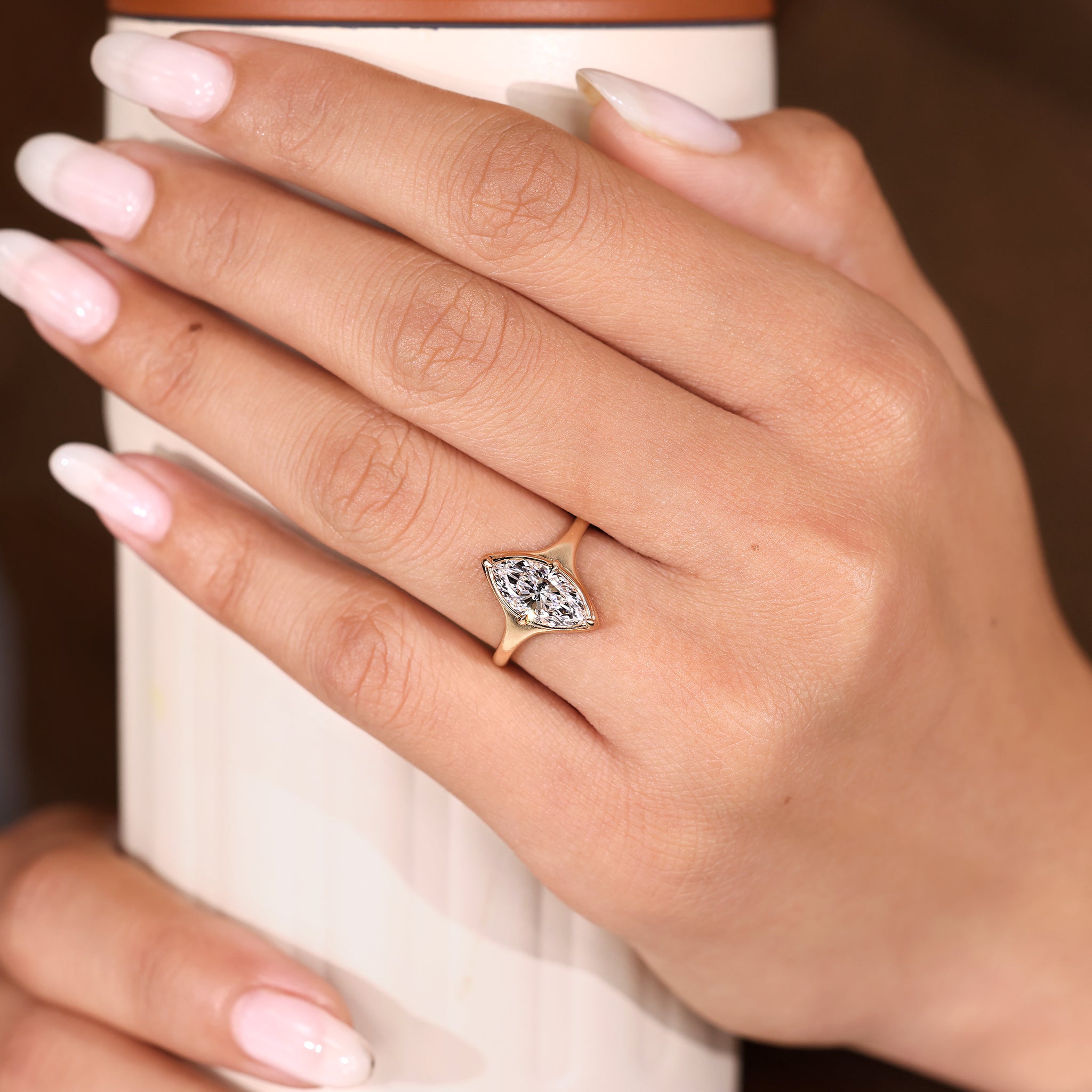 Marquise diamond ring with tapered shank and solitaire setting.
