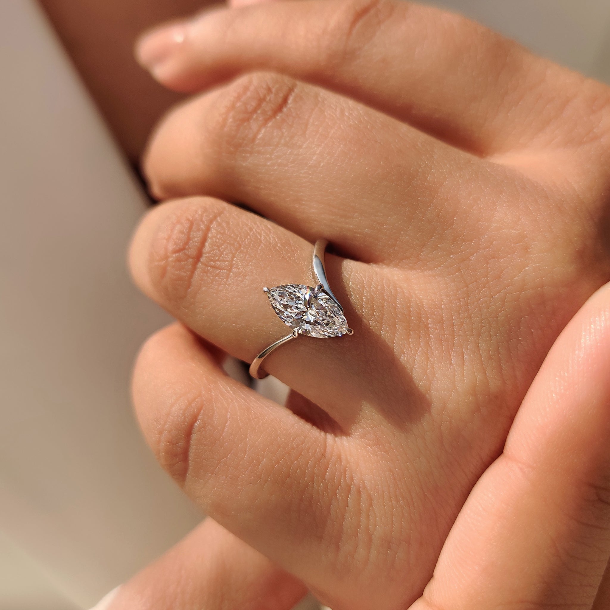 Handmade marquise solitaire ring with unique upside down design.
