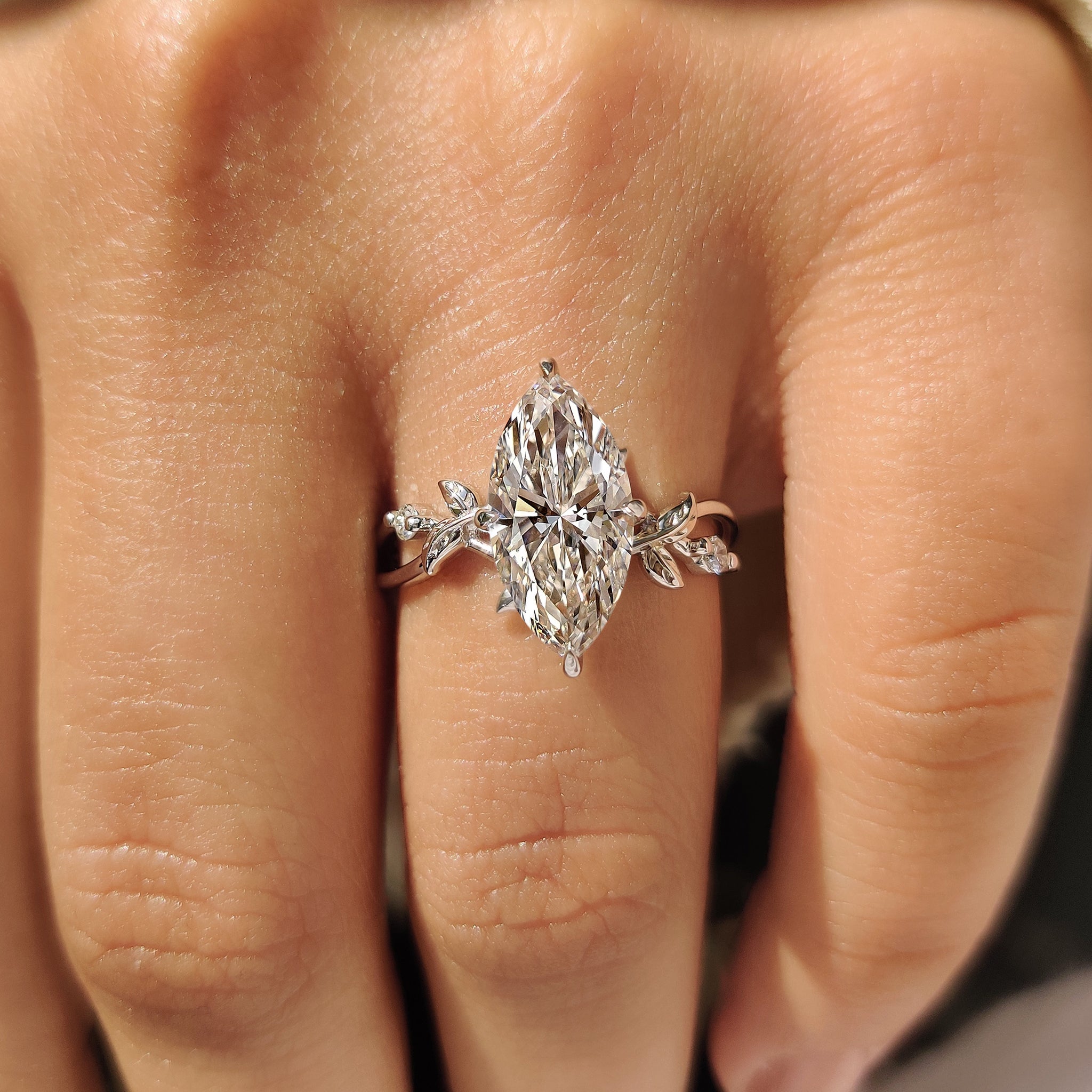 Handmade marquise diamond ring with round side accents.
