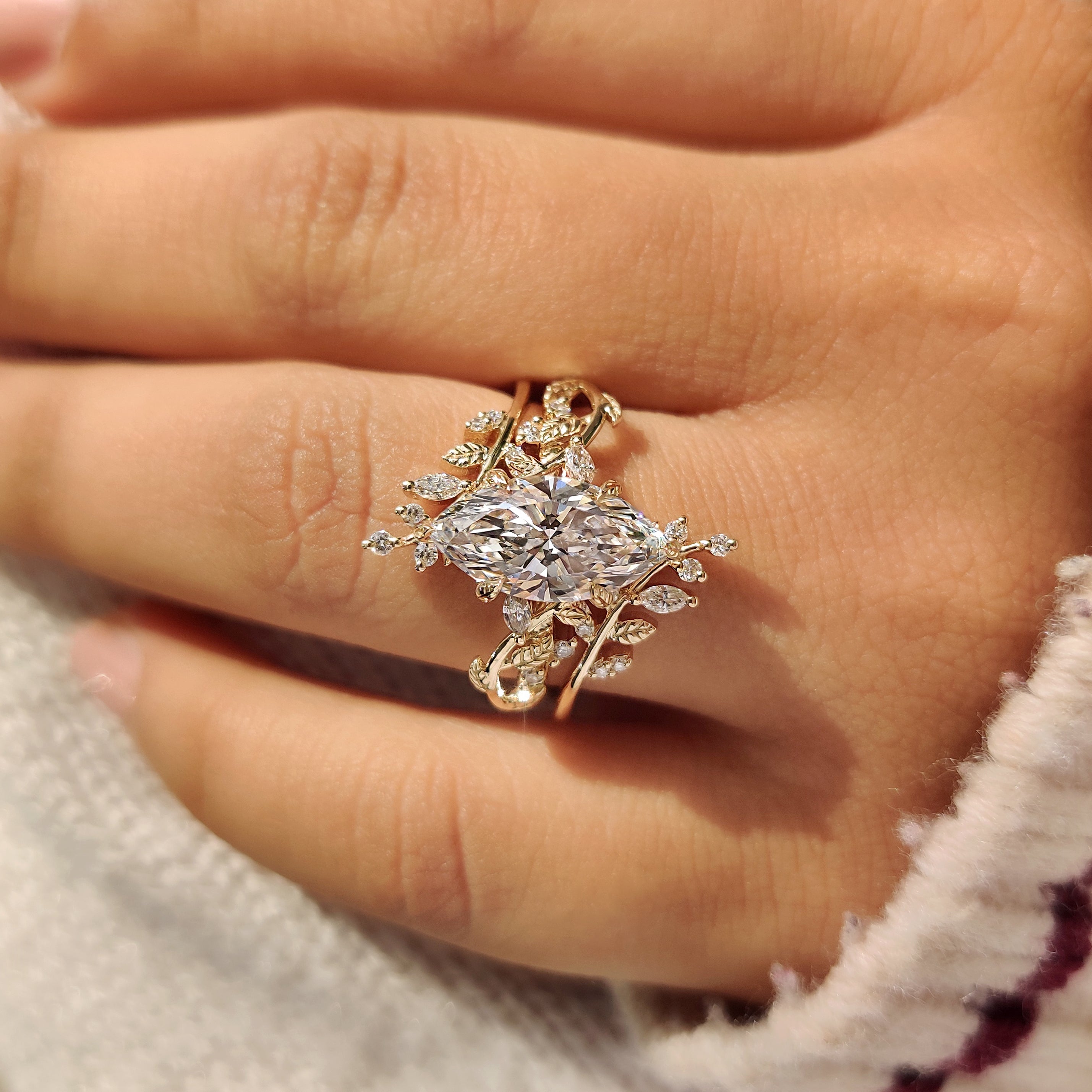 Marquise diamond ring with round side stones and leaves
