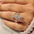 Marquise diamond ring with round side stones and leaves
