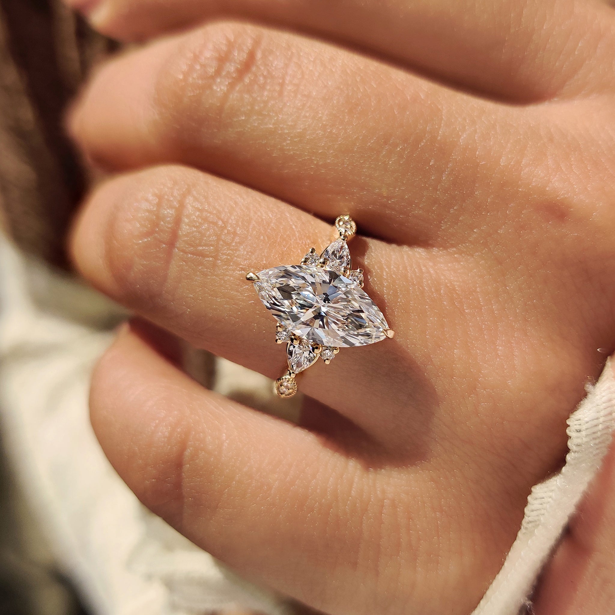 Marquise diamond ring with muse setting and side stones.
