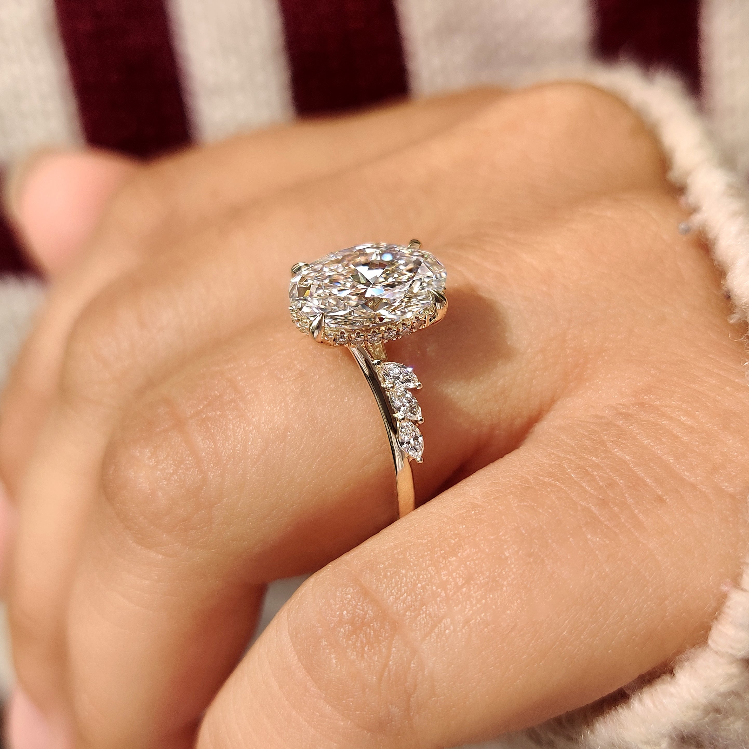 Oval centre diamond with marquise side stones.
