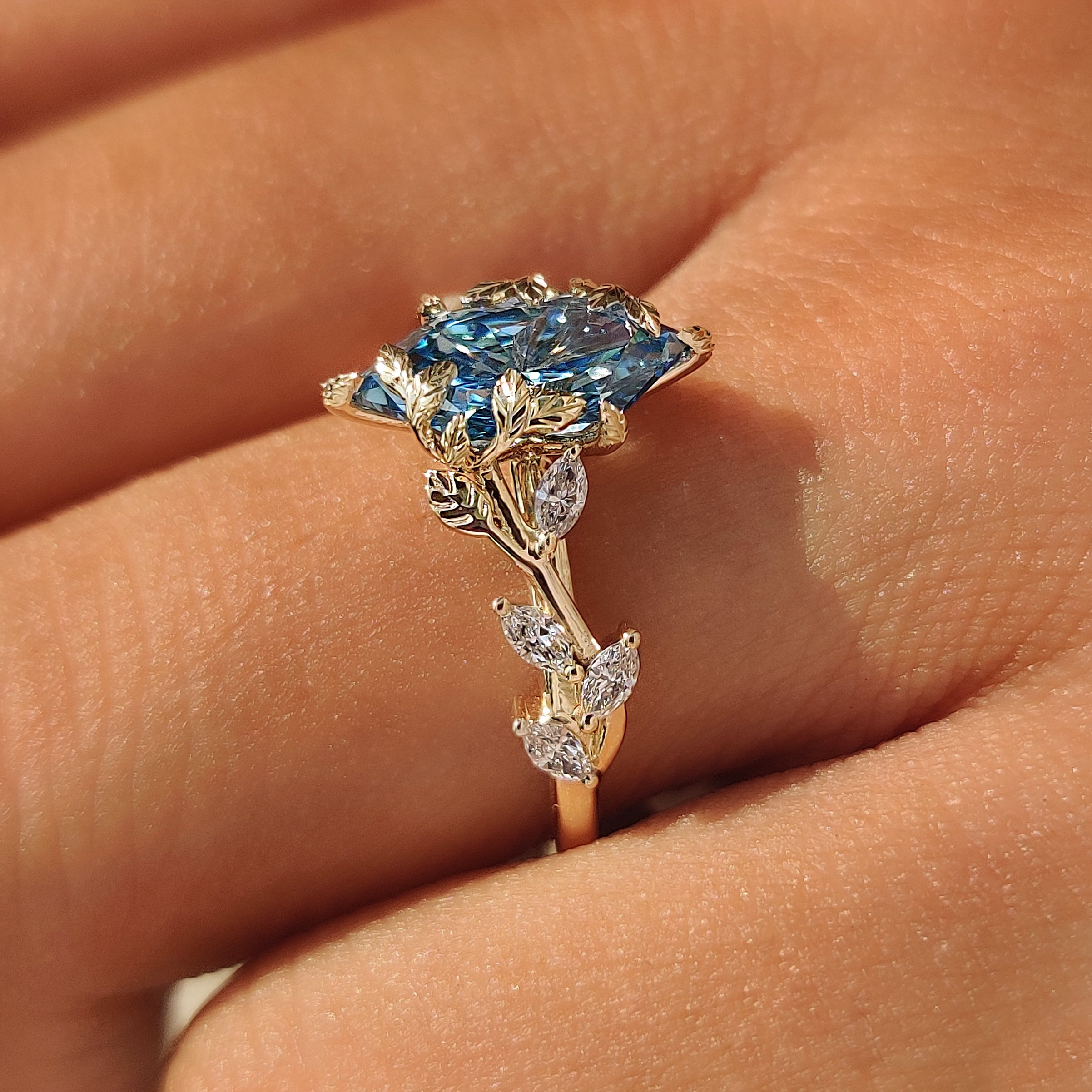 Branching vine design along the engagement ring shoulders.
