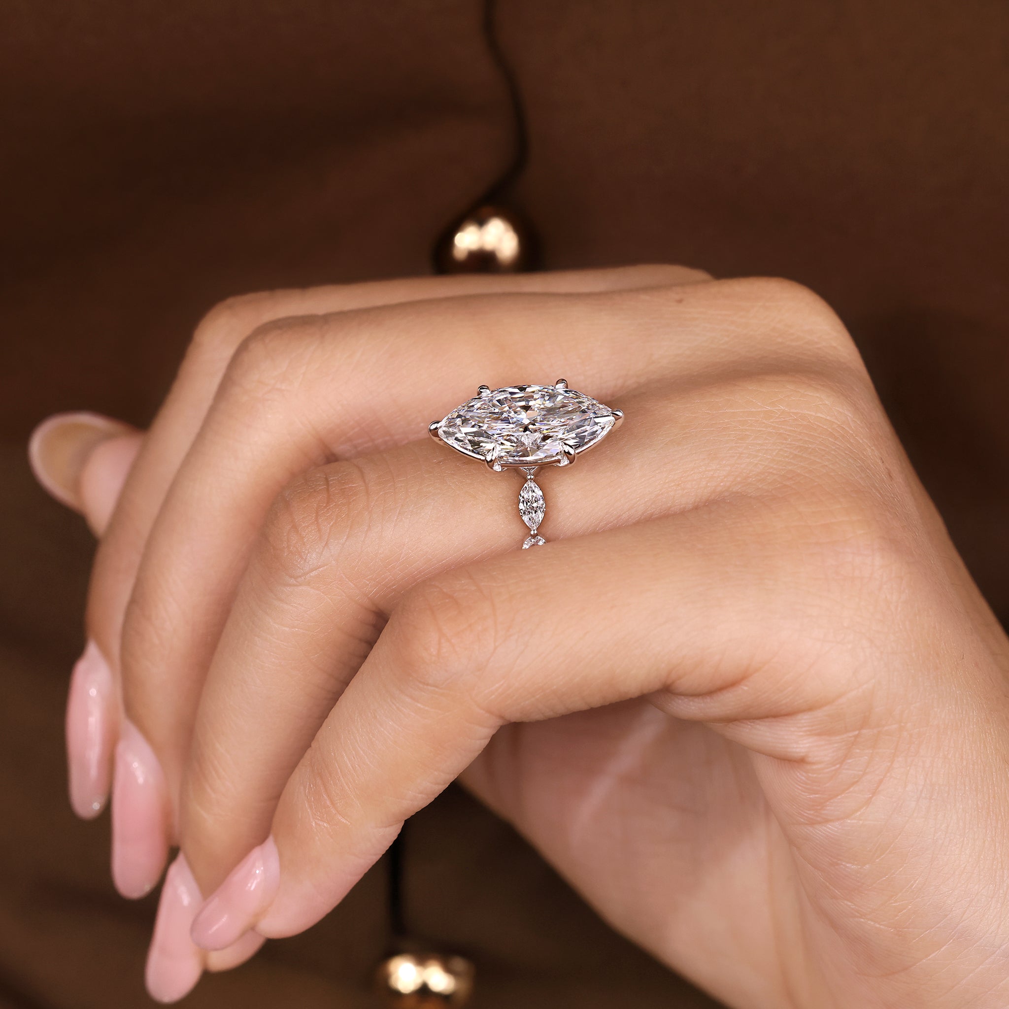 Marquise diamond ring featuring marquise and round side stones
