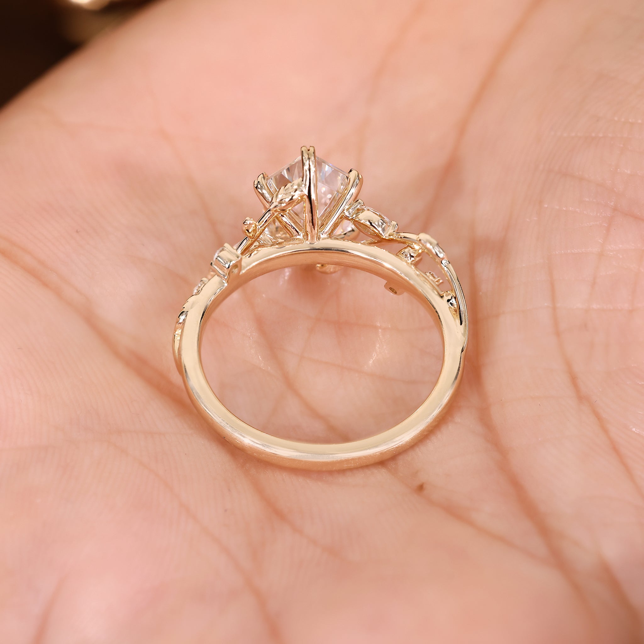 Hexagon step cut diamond ring with six leaf style prong
