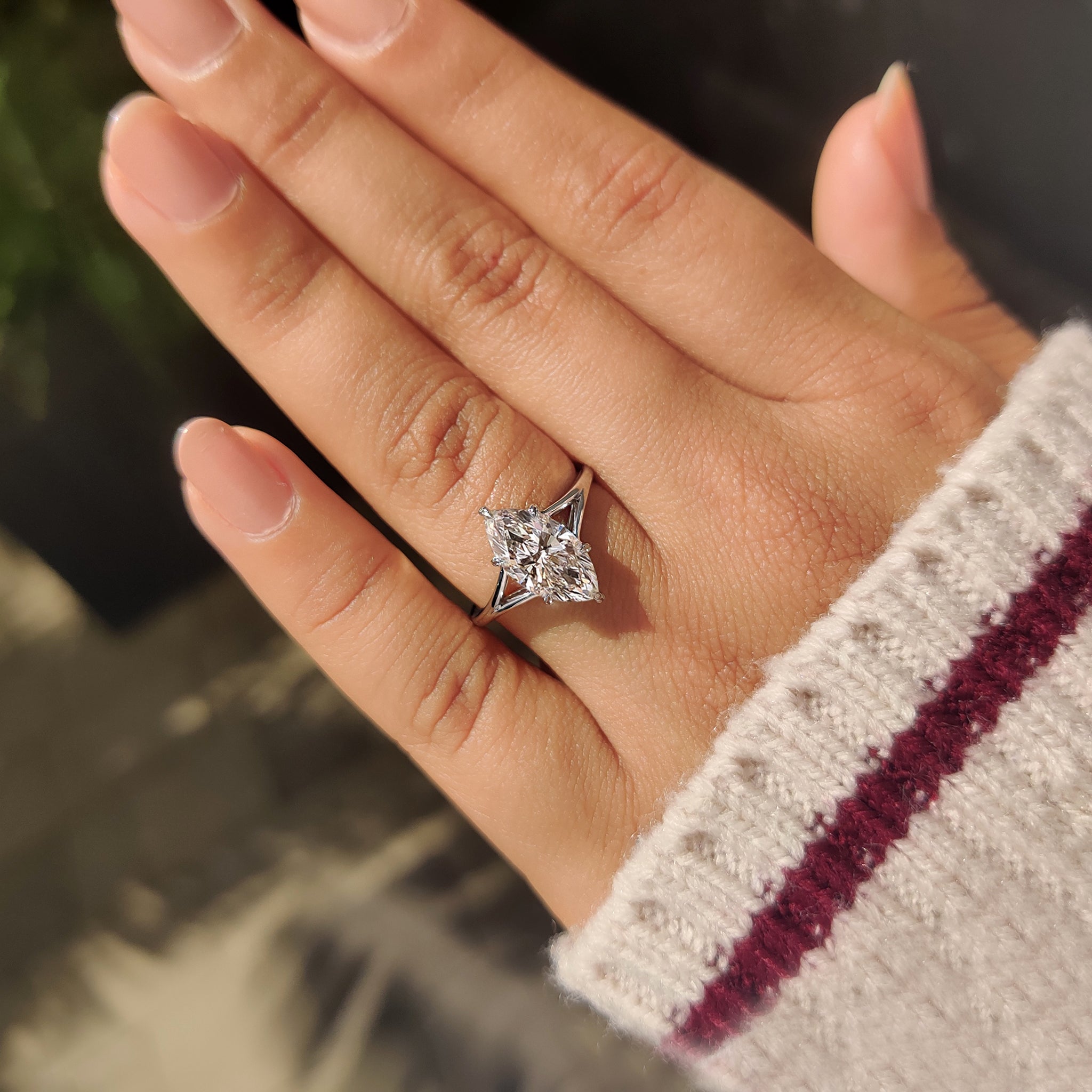 Marquise solitaire diamond ring with six leaf style prong.
