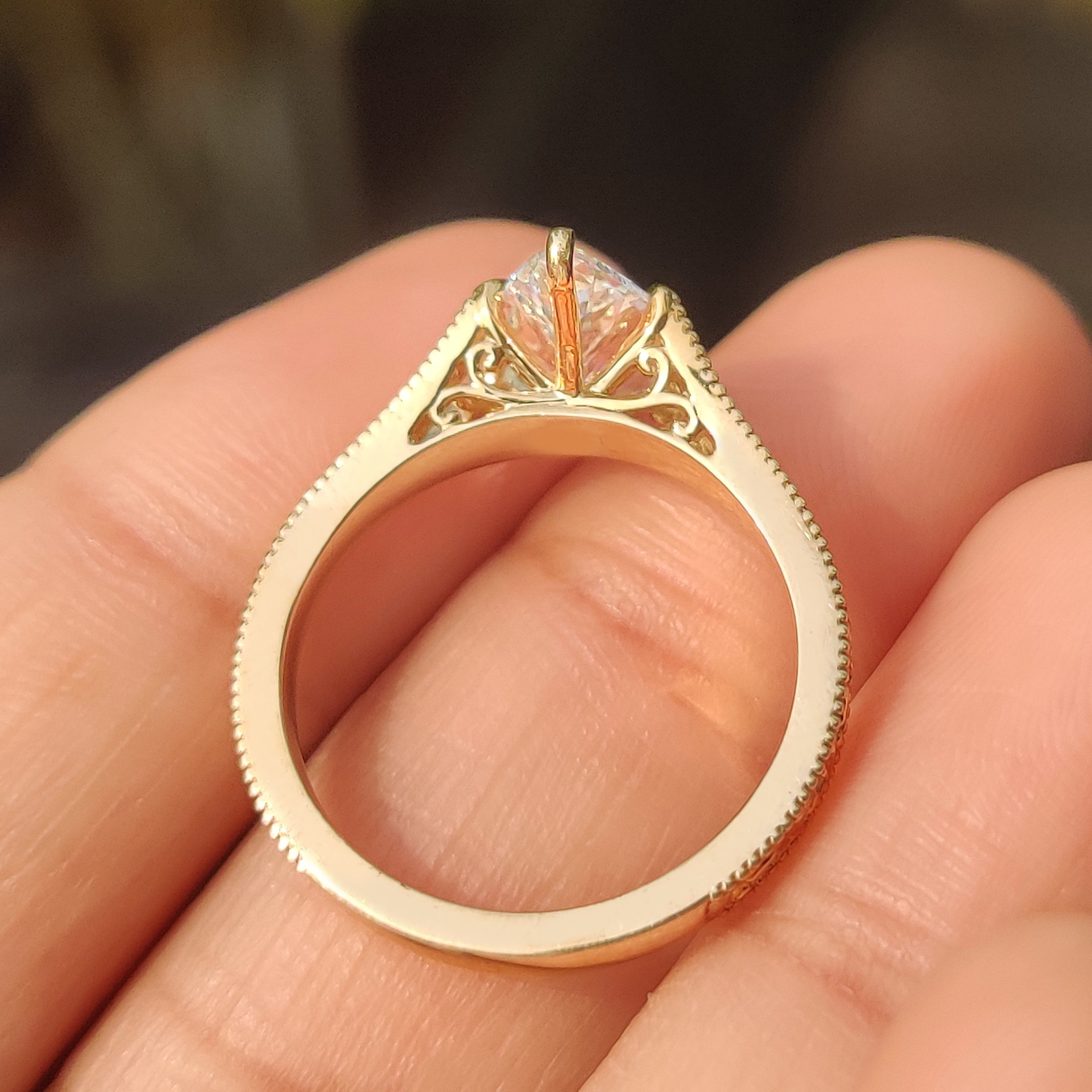 Vintage style marquise diamond ring with milgrain edge details.
