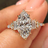 Marquise cut engagement ring with baguette, marquise and round side stones.
