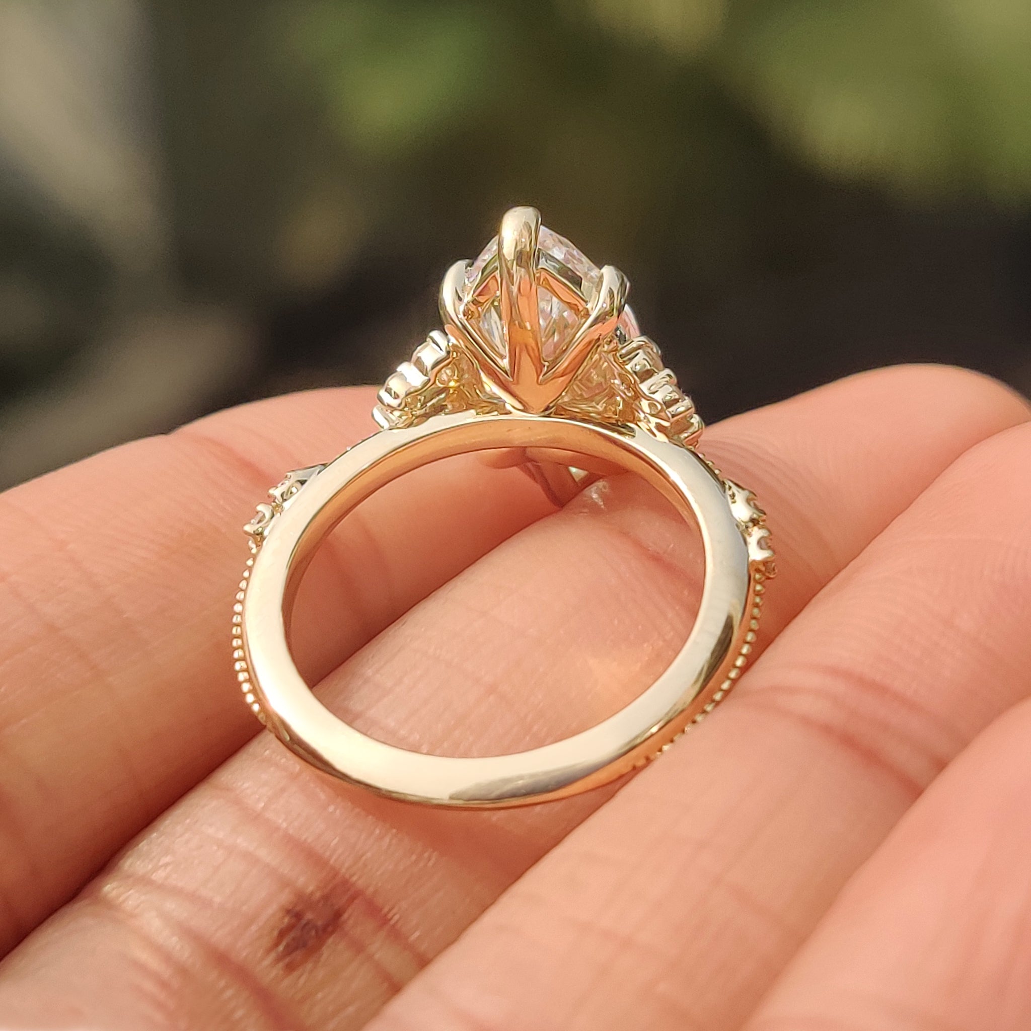 Marquise engagement ring with marquise and round side stones
