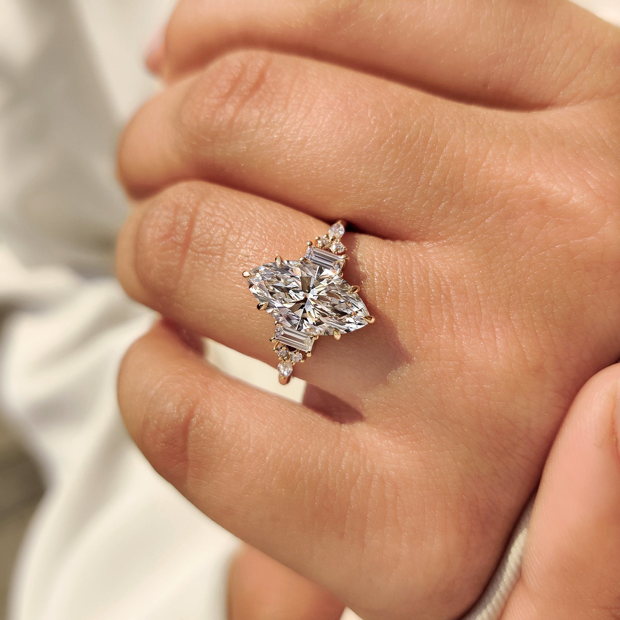 Lab grown marquise engagement ring with baguette stones.
