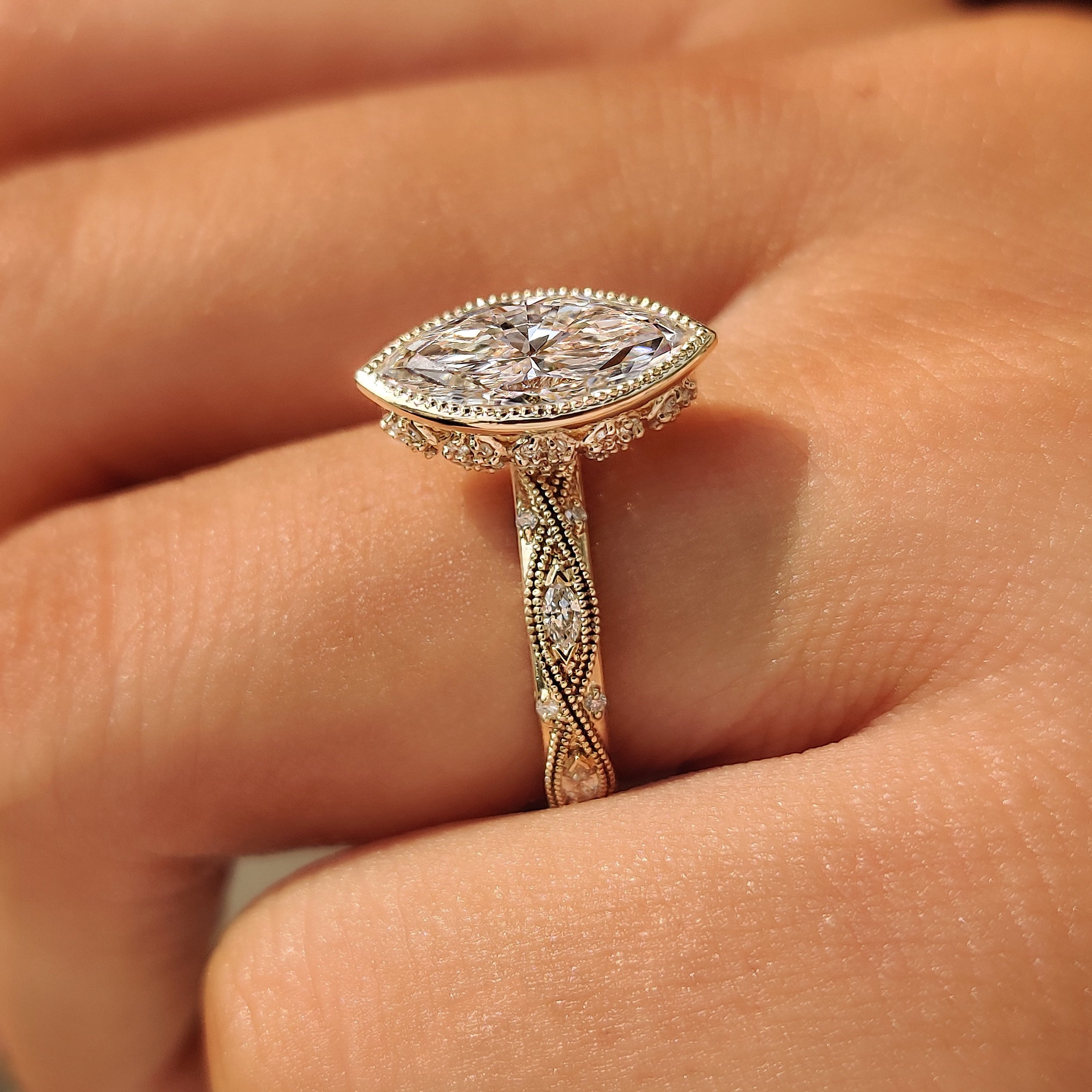 Side view of a marquise engagement ring with floral basket gallery.
