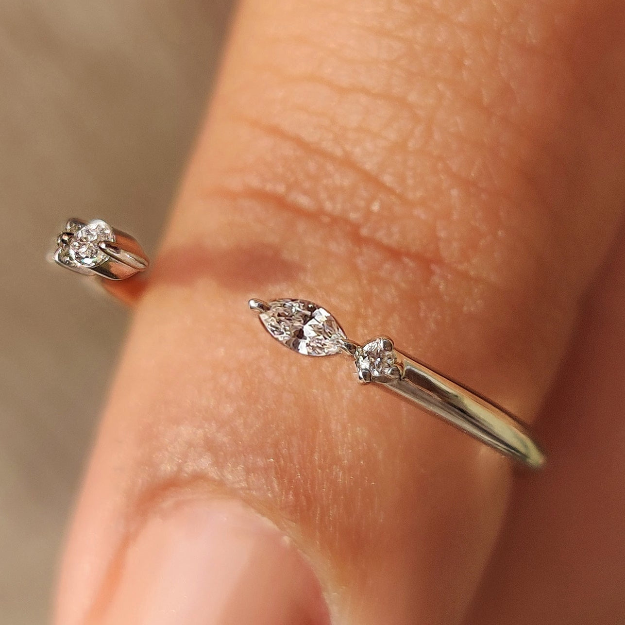 Marquise and round diamond band in open gap style.
