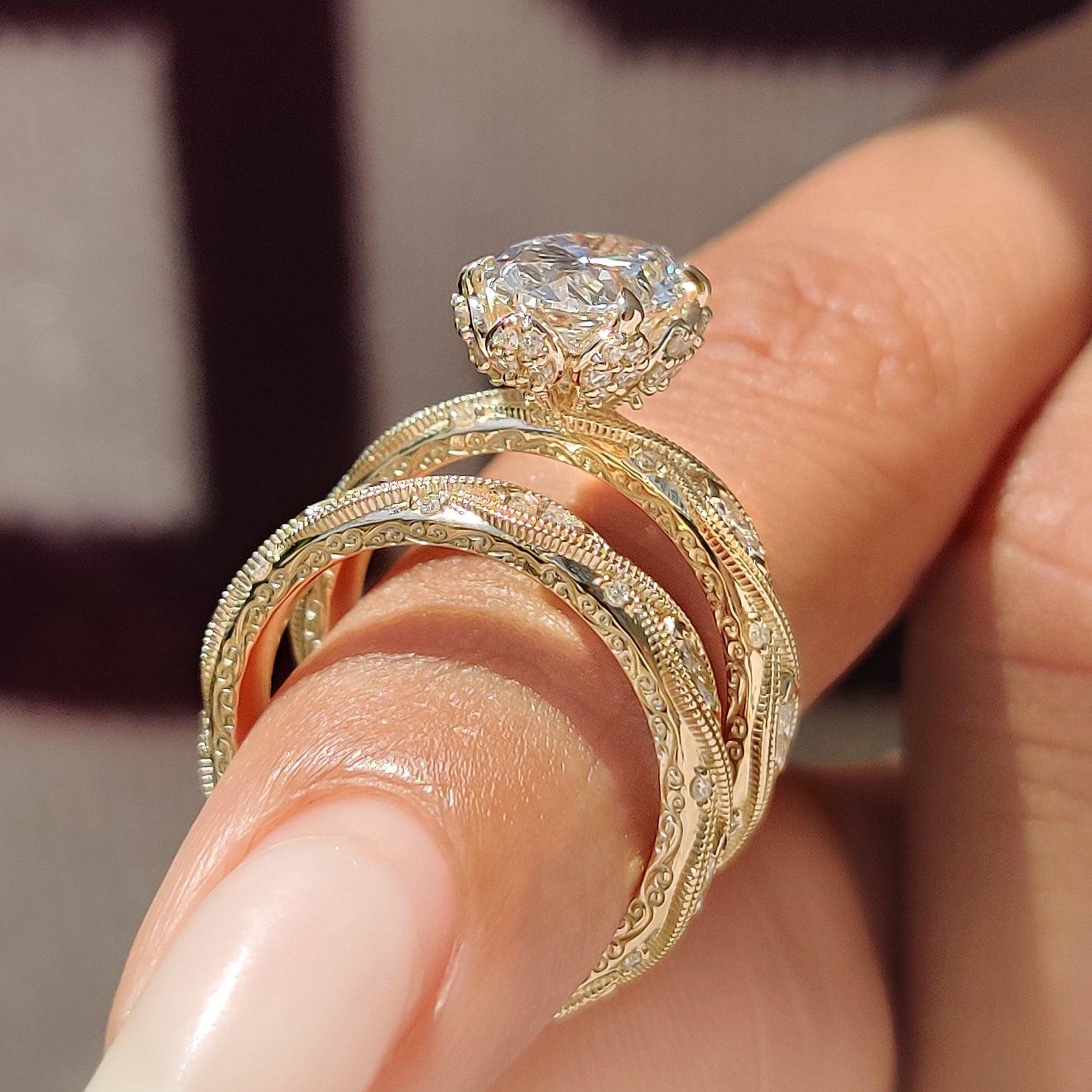 Oval cut ring with four claw prong and marquise side stones.

