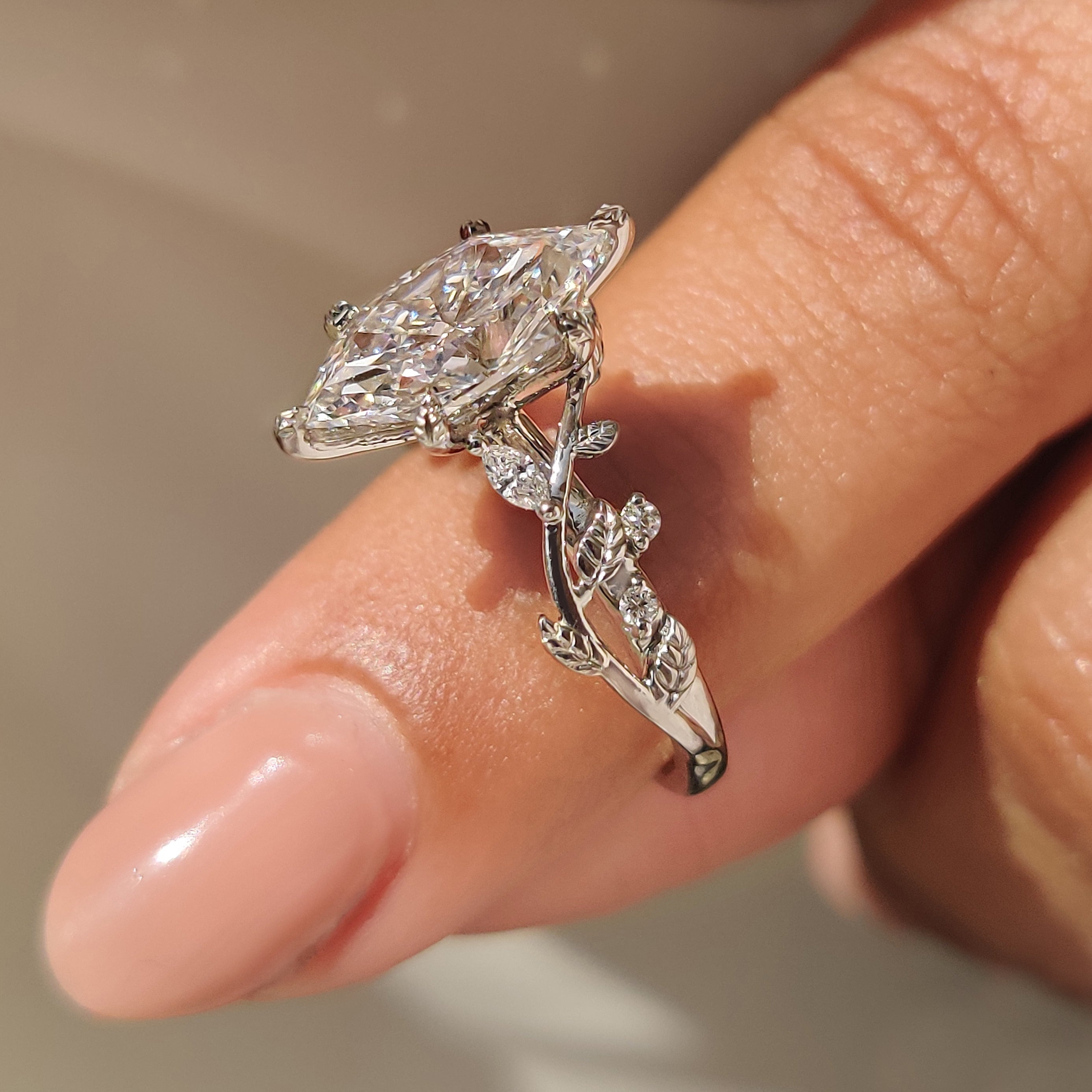 Lab grown marquise diamond ring with nature inspired design.
