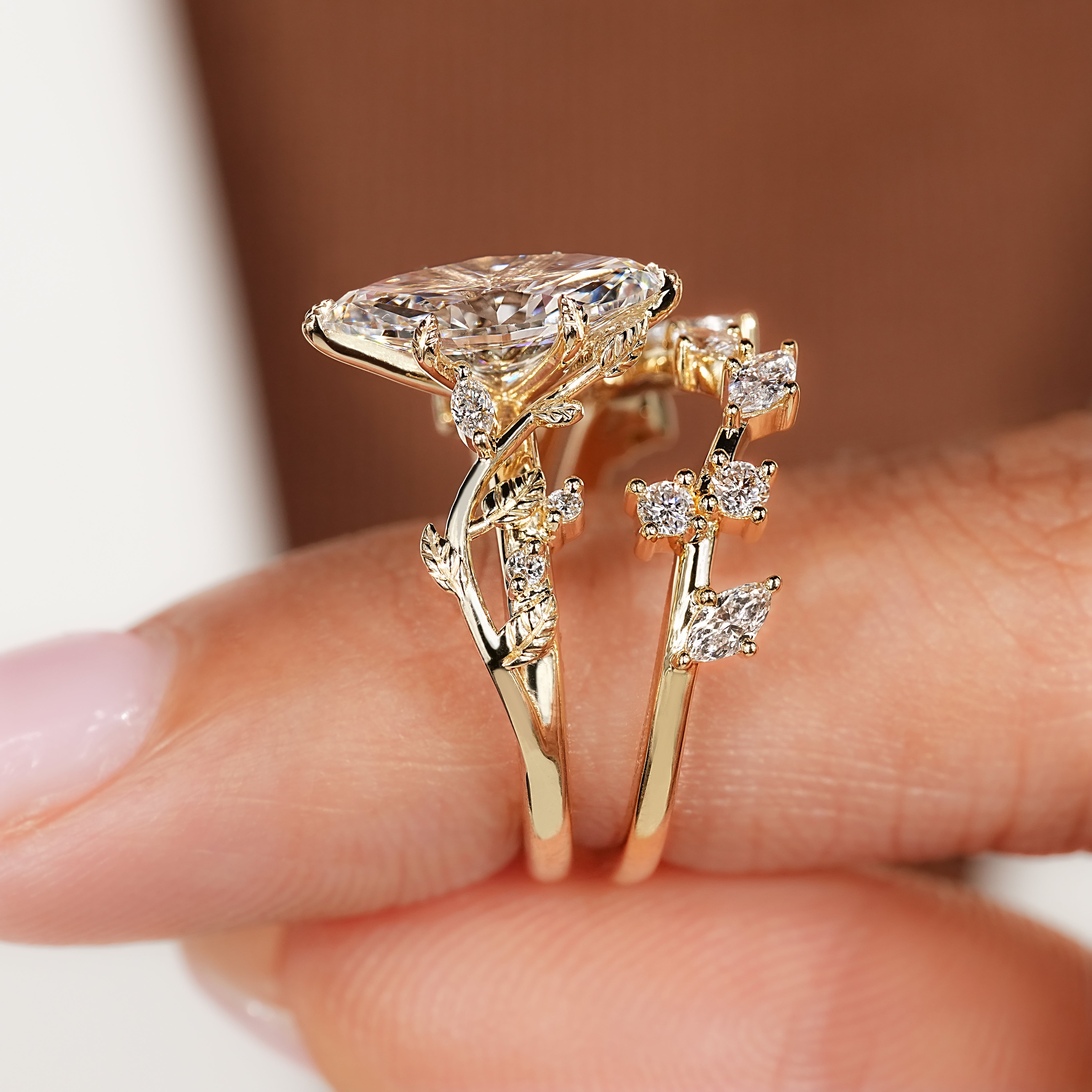 Nature inspired marquise ring with decorative vine branches.
