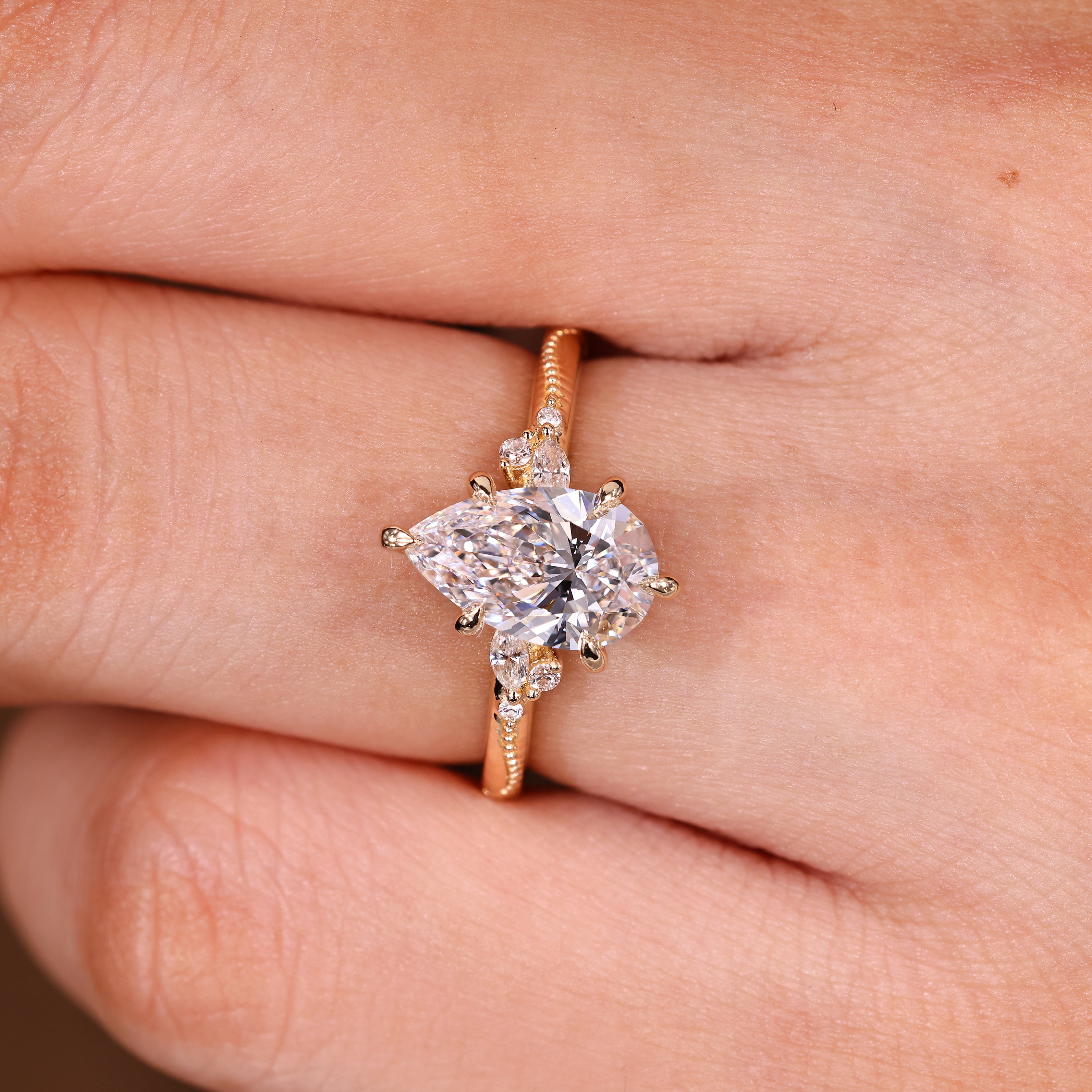 Lab grown pear diamond ring with six claw prongs
