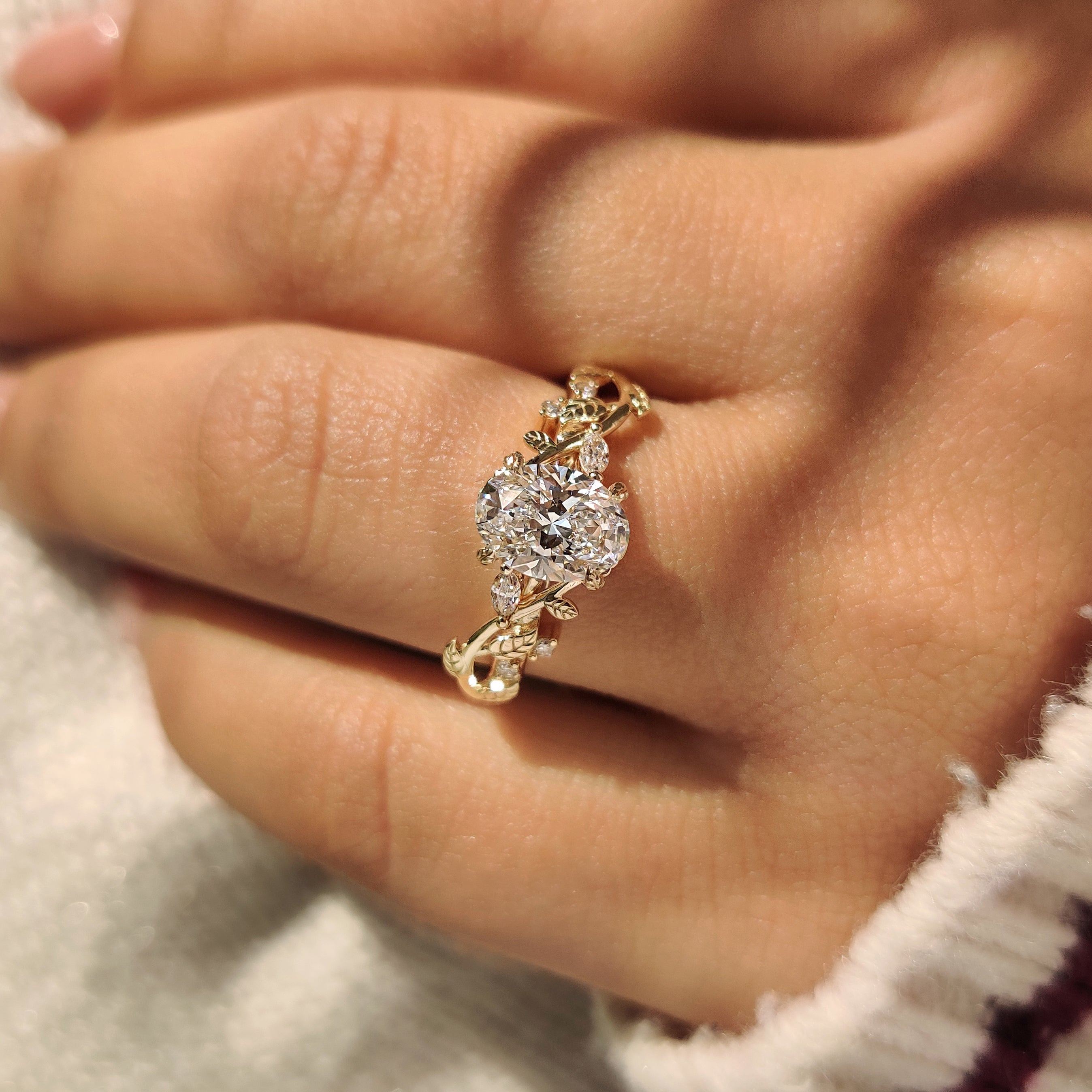 Oval lab grown diamond ring with leaf style prongs.
