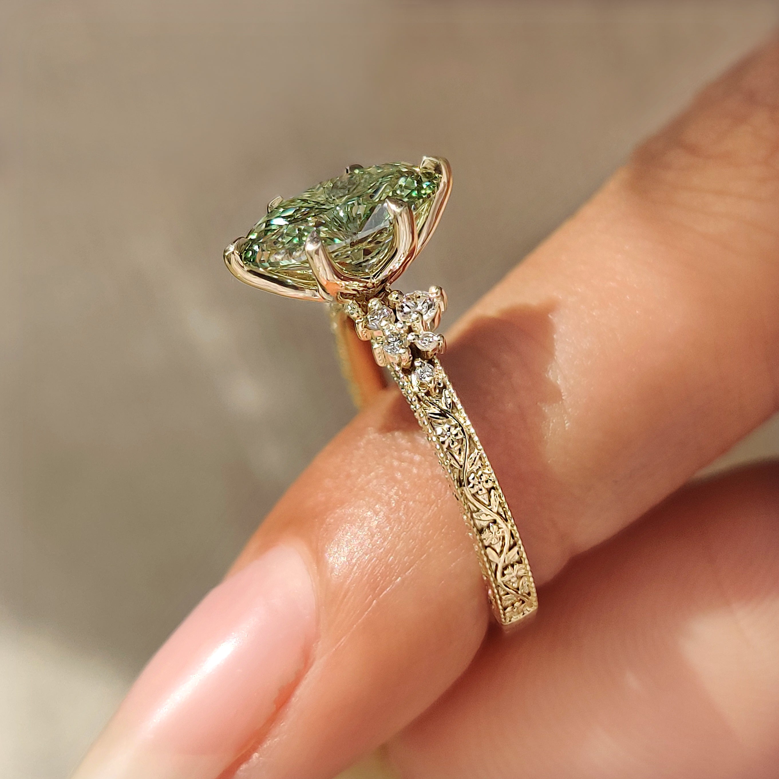 Vintage green oval diamond ring with milgrain details
