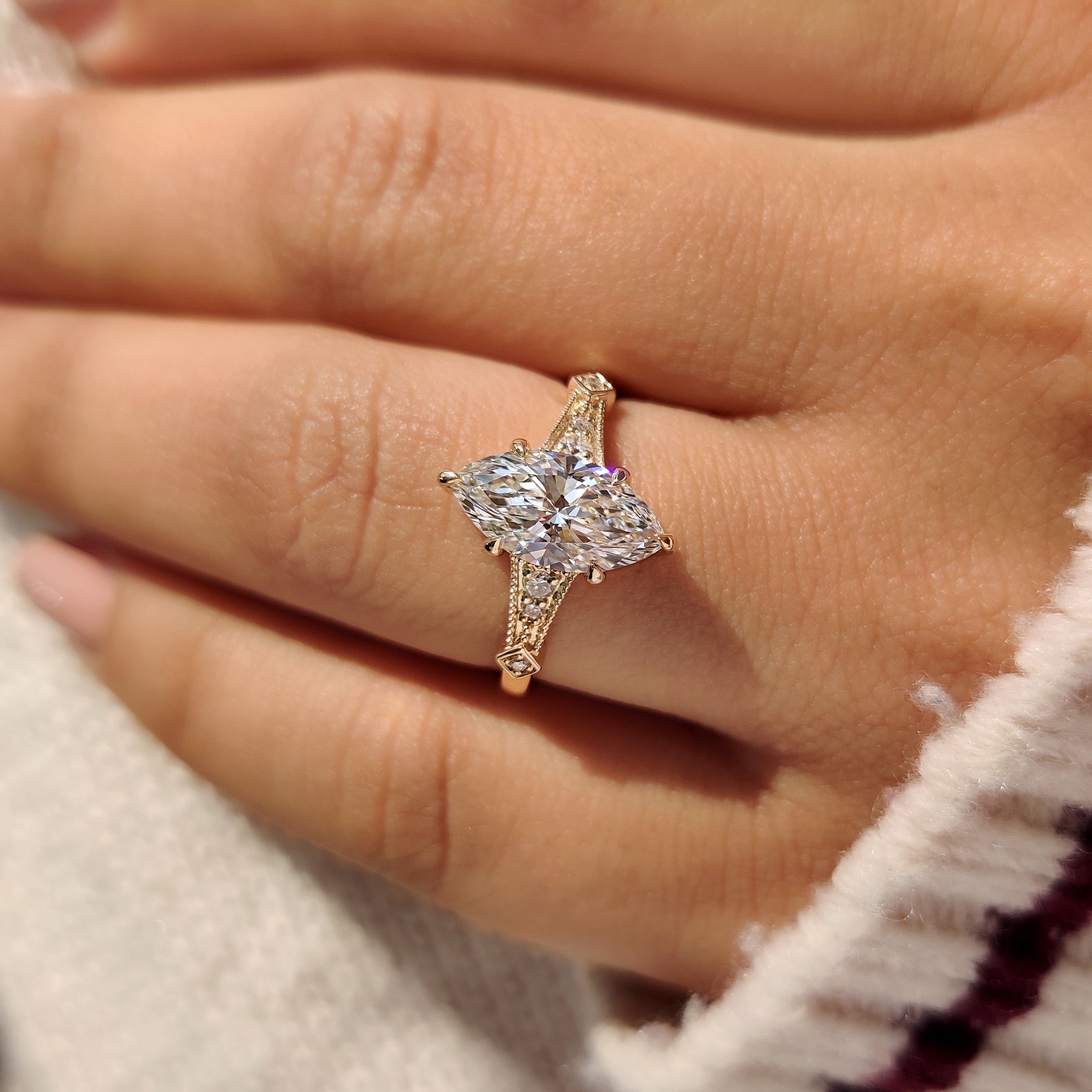 Marquise lab diamond ring with milgrain and cathedral design.
