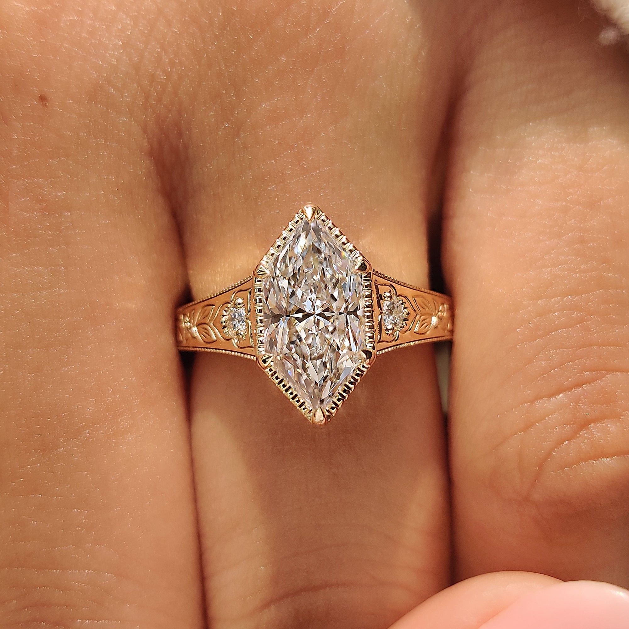 Dutch marquise center diamond secured by six claw prongs.
