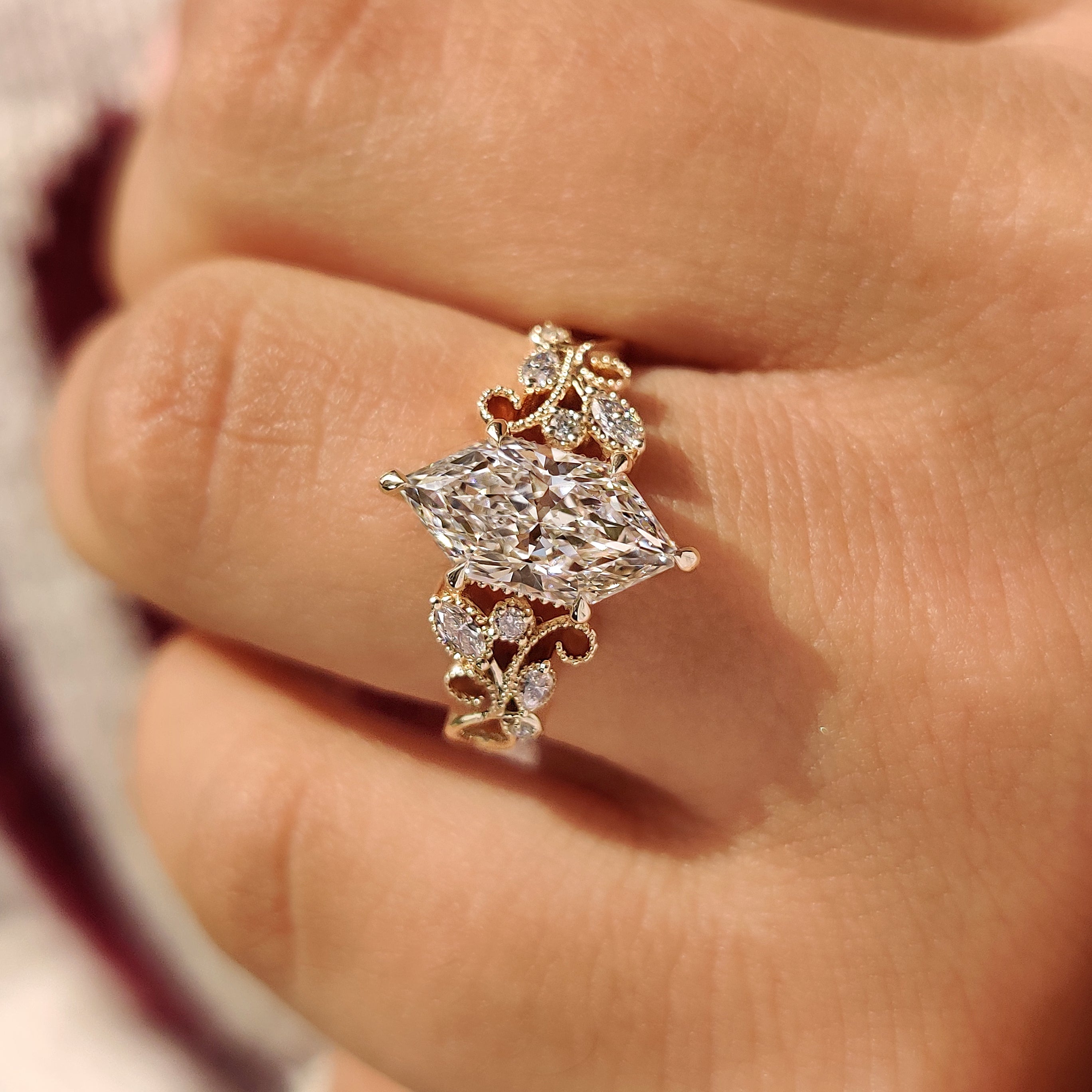 Floral details around dutch marquise center diamond
