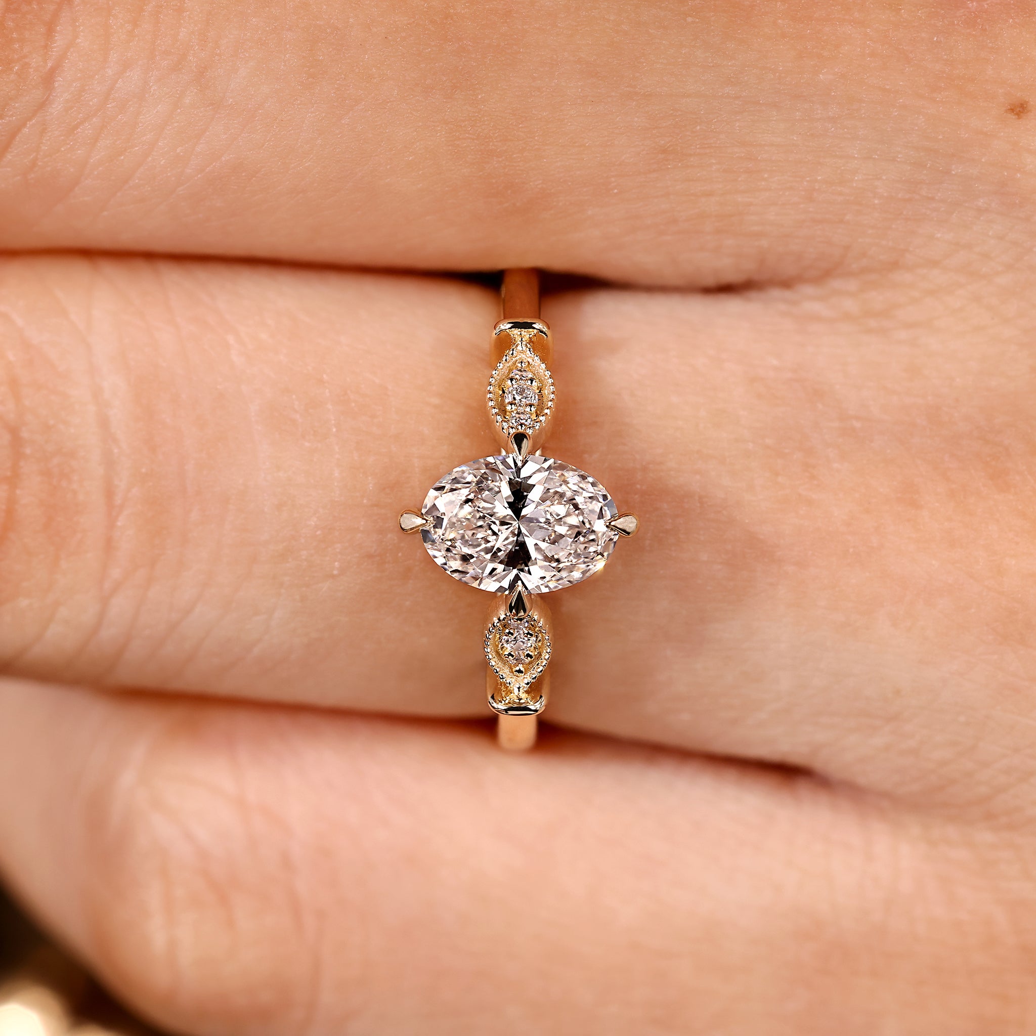 Lab grown diamond ring with oval center and side stones
