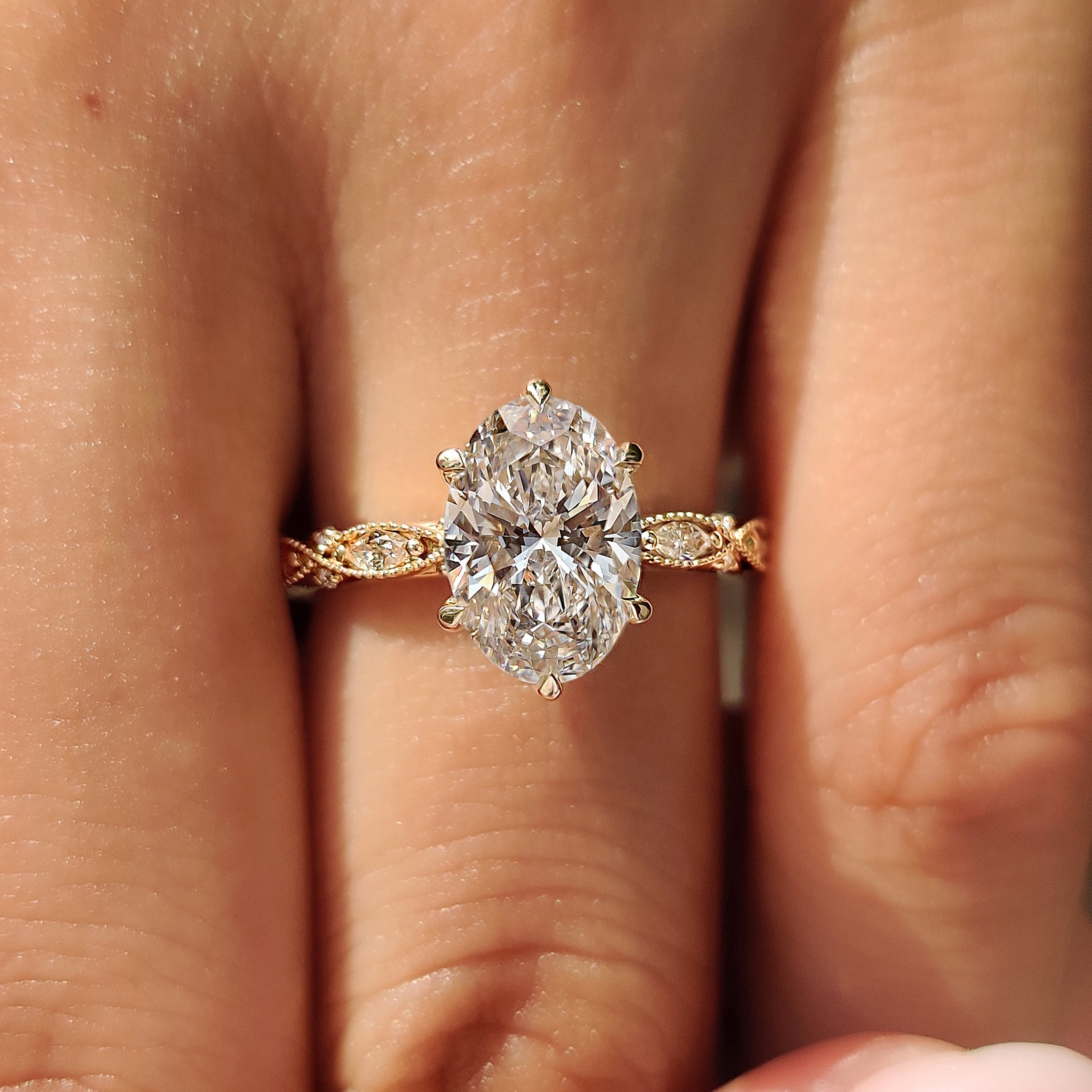 Lab grown oval diamond ring with marquise and round accents
