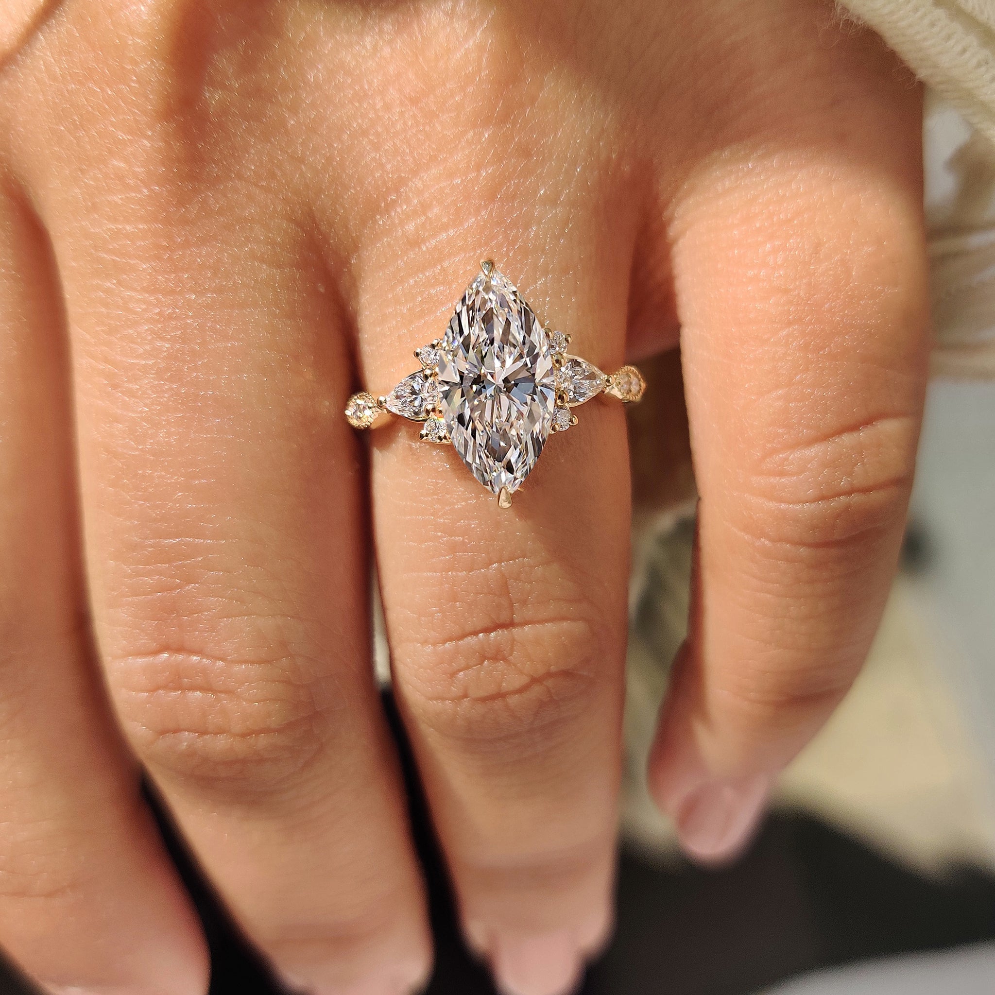 Handmade marquise cut ring with detailed milgrain outline.
