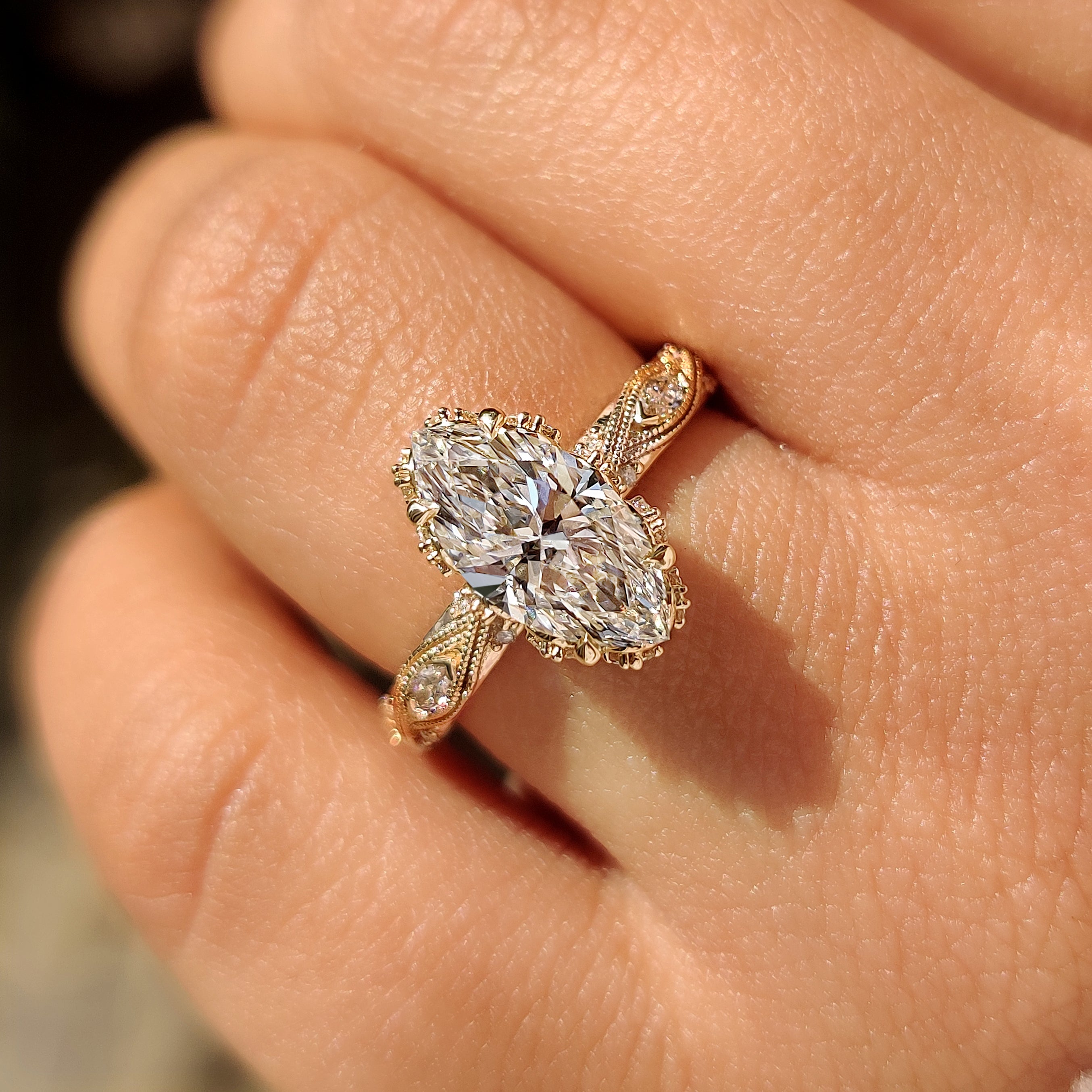 Marquise cut diamond ring with filigree shank.
