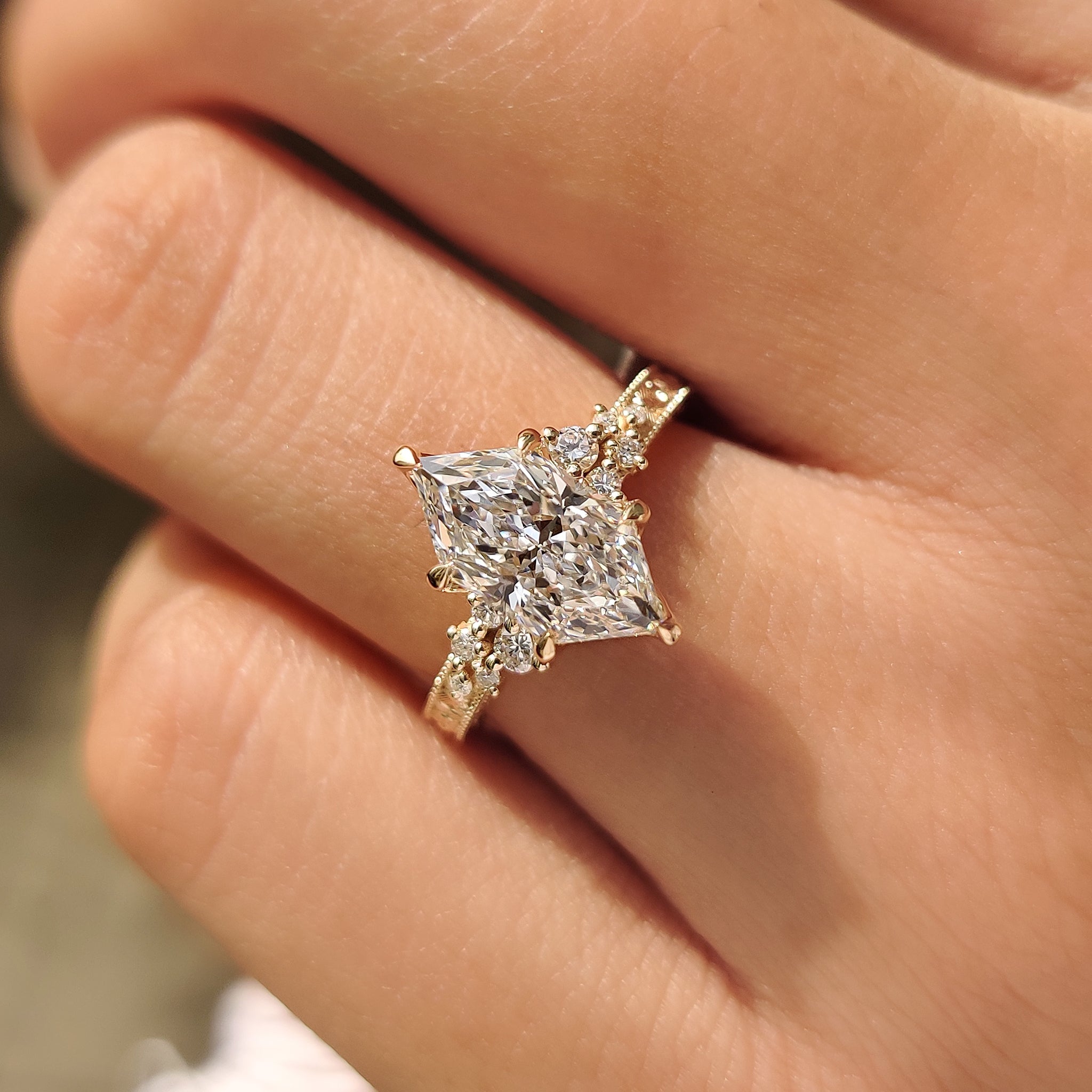 Nature inspired diamond ring with floral design and milgrain.
