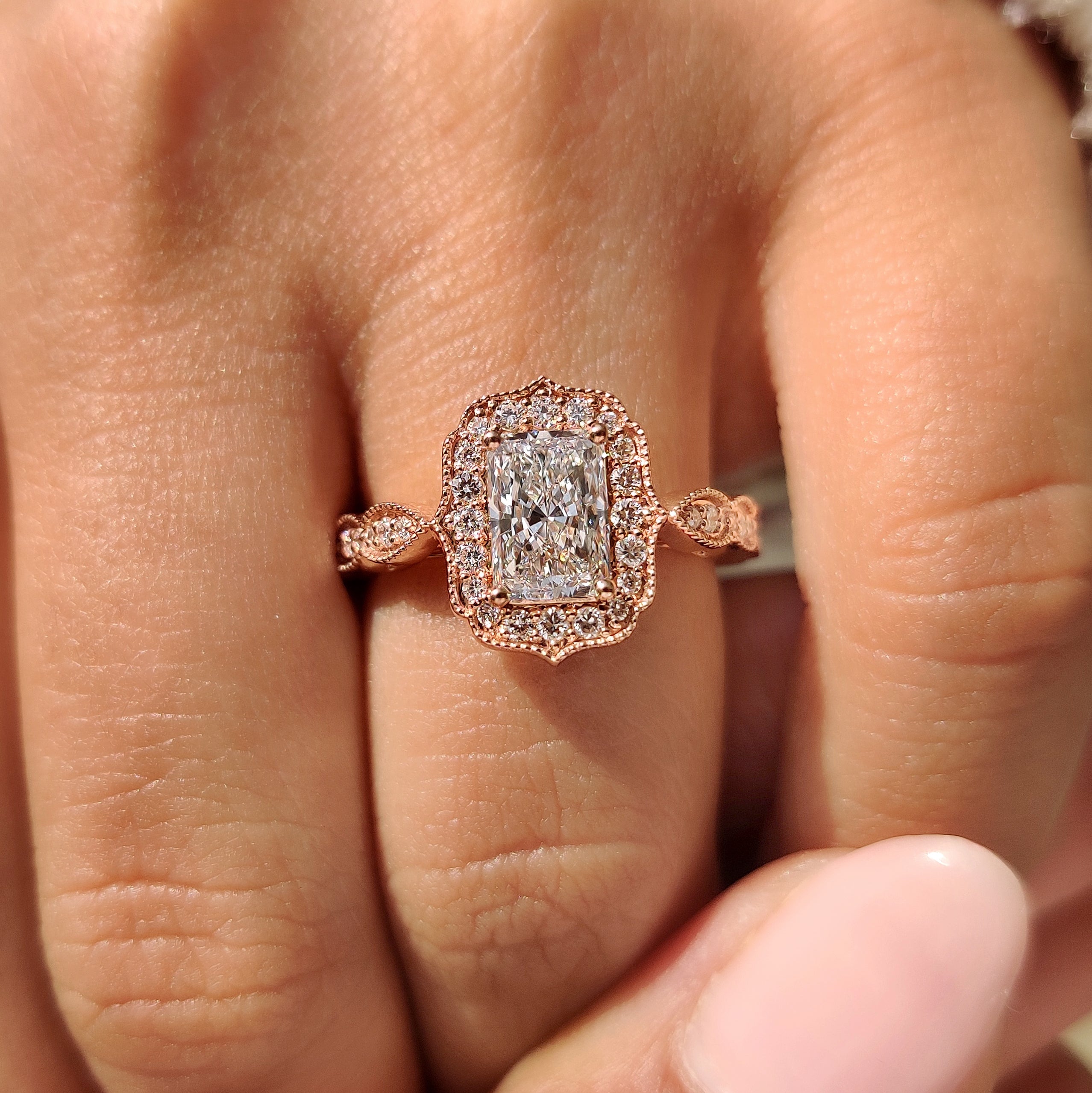 Radiant diamond ring with milgrain and halo setting.
