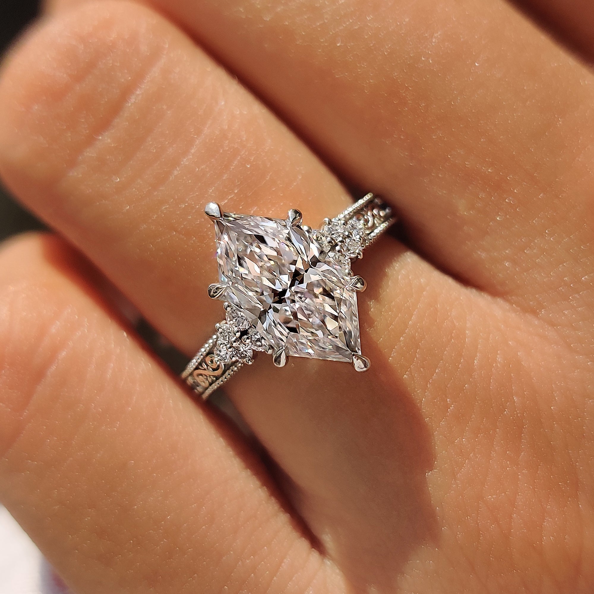 Filigree engraving along the shank of a Dutch marquise engagement ring.
