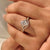 Oval lab diamond ring with round side stones and band.
